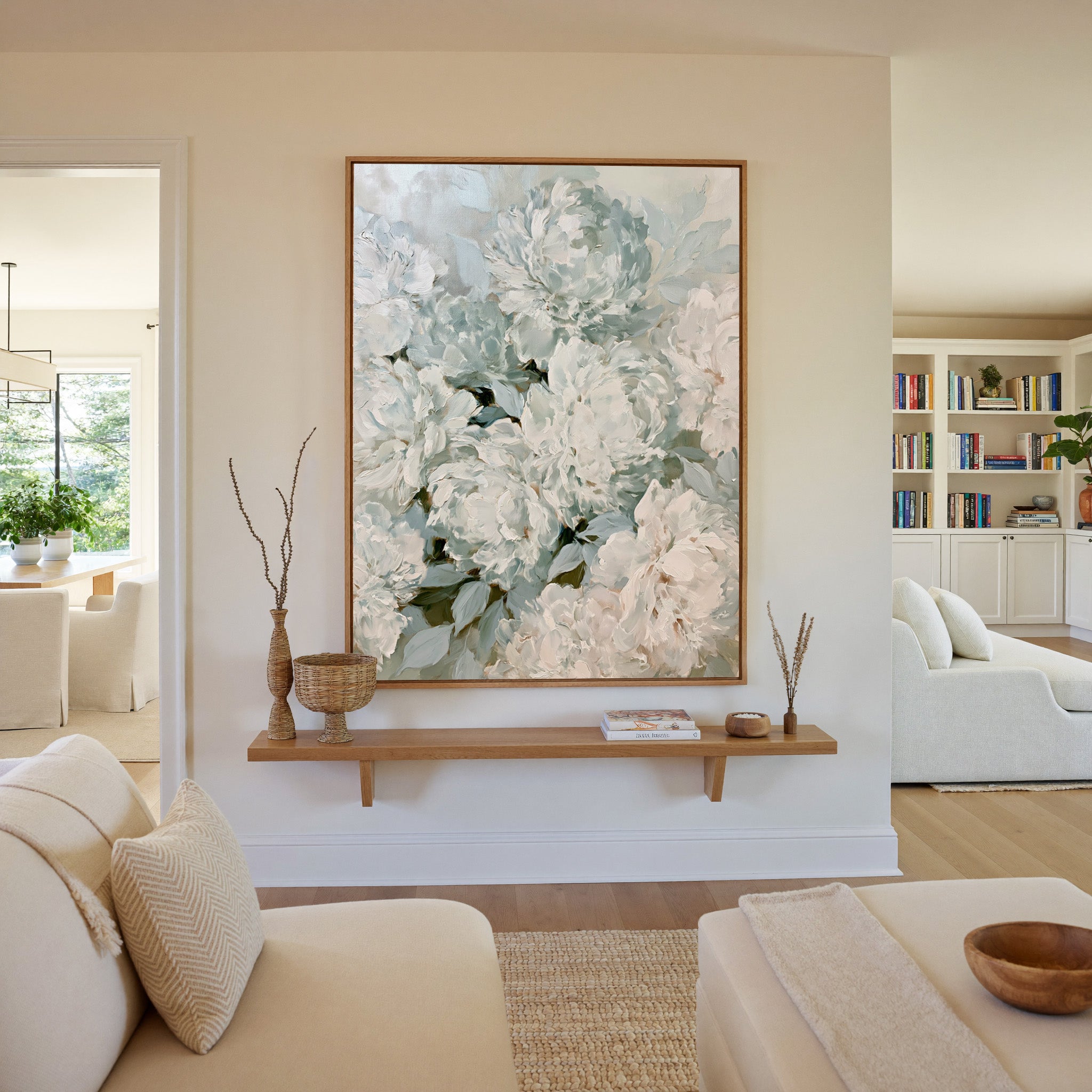 soft white and blush peony bouquet canvas wall art in an oak frame in a living room
