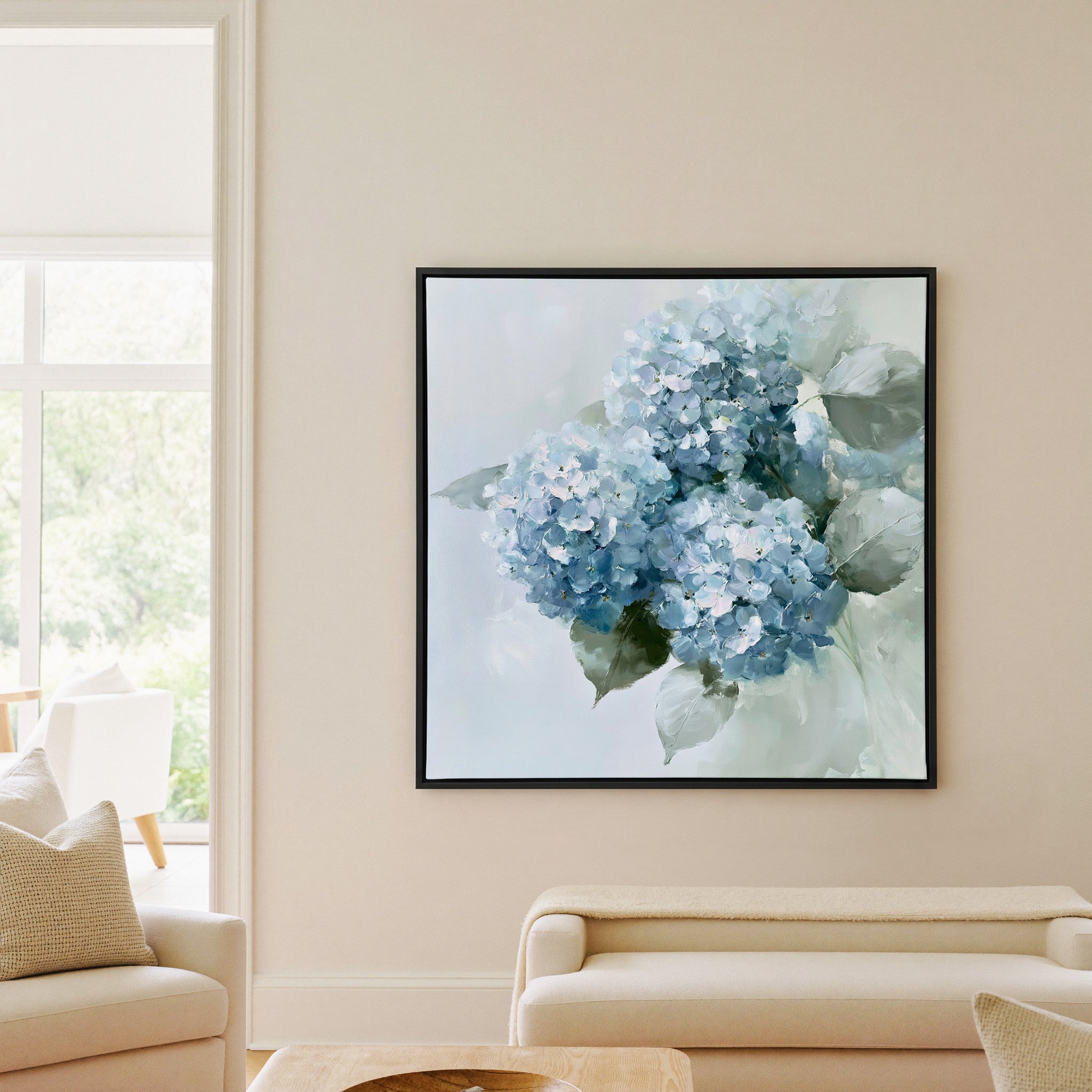 dusty blue hydrangea bouquet with pale green canvas wall art in a black frame in a living room