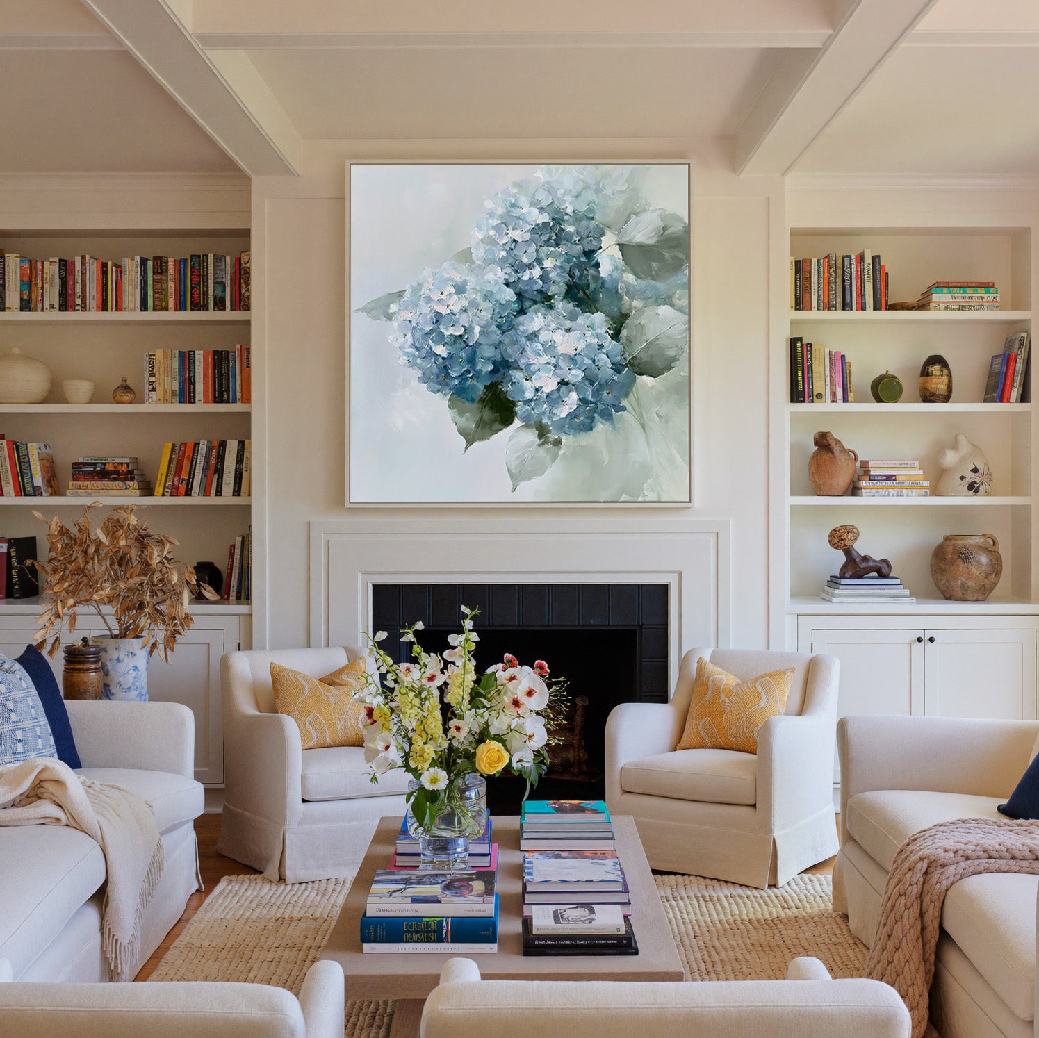 dusty blue hydrangea bouquet with pale green canvas wall art in a white frame above a fireplace