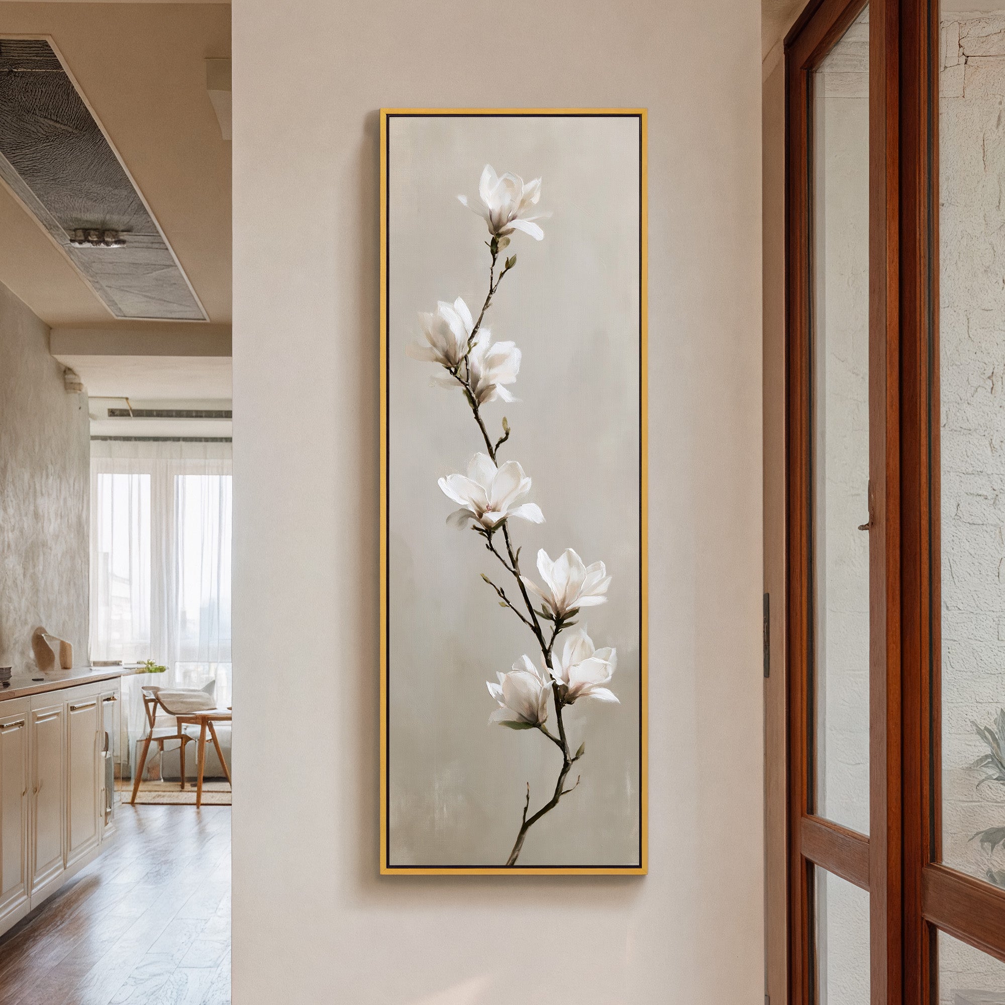 single white magnolia branch on a soft beige canvas wall art in a gold frame in a styled room setting