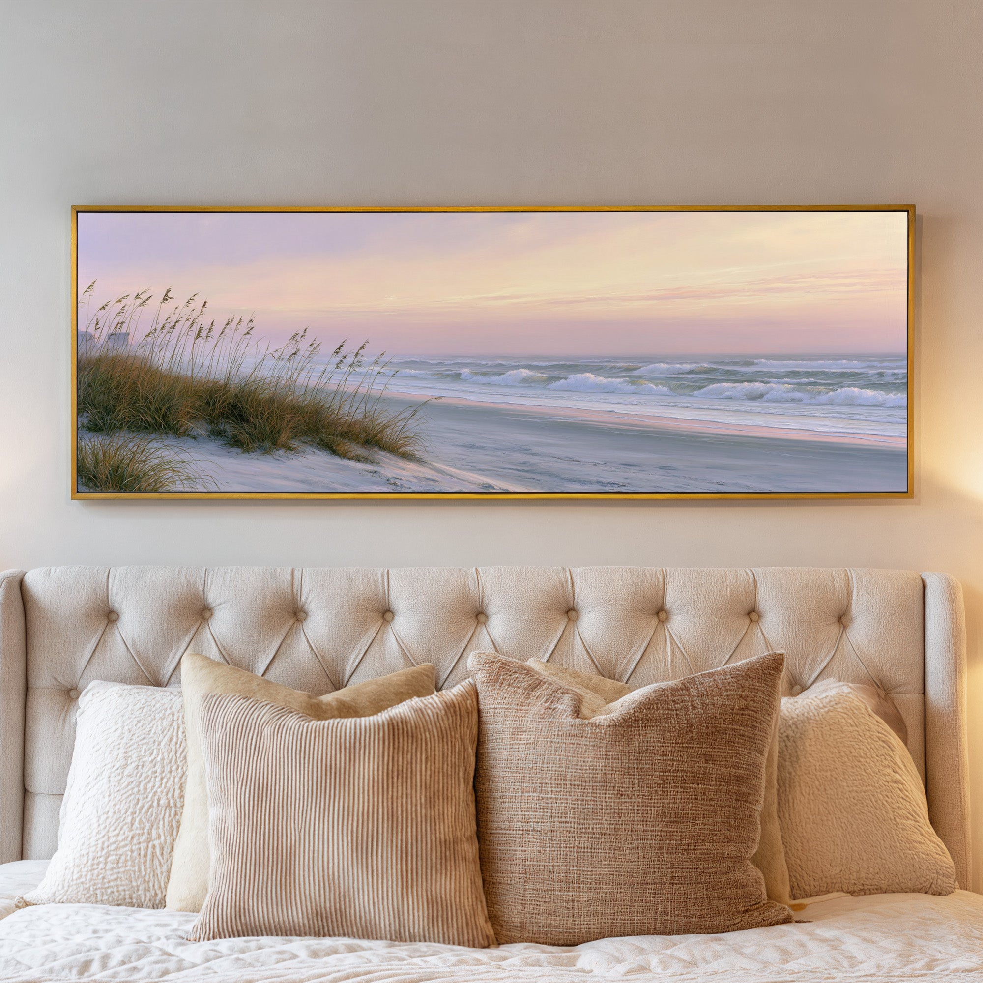 windswept beach at dusk with pale surf and dune canvas wall art in a gold frame above a bed