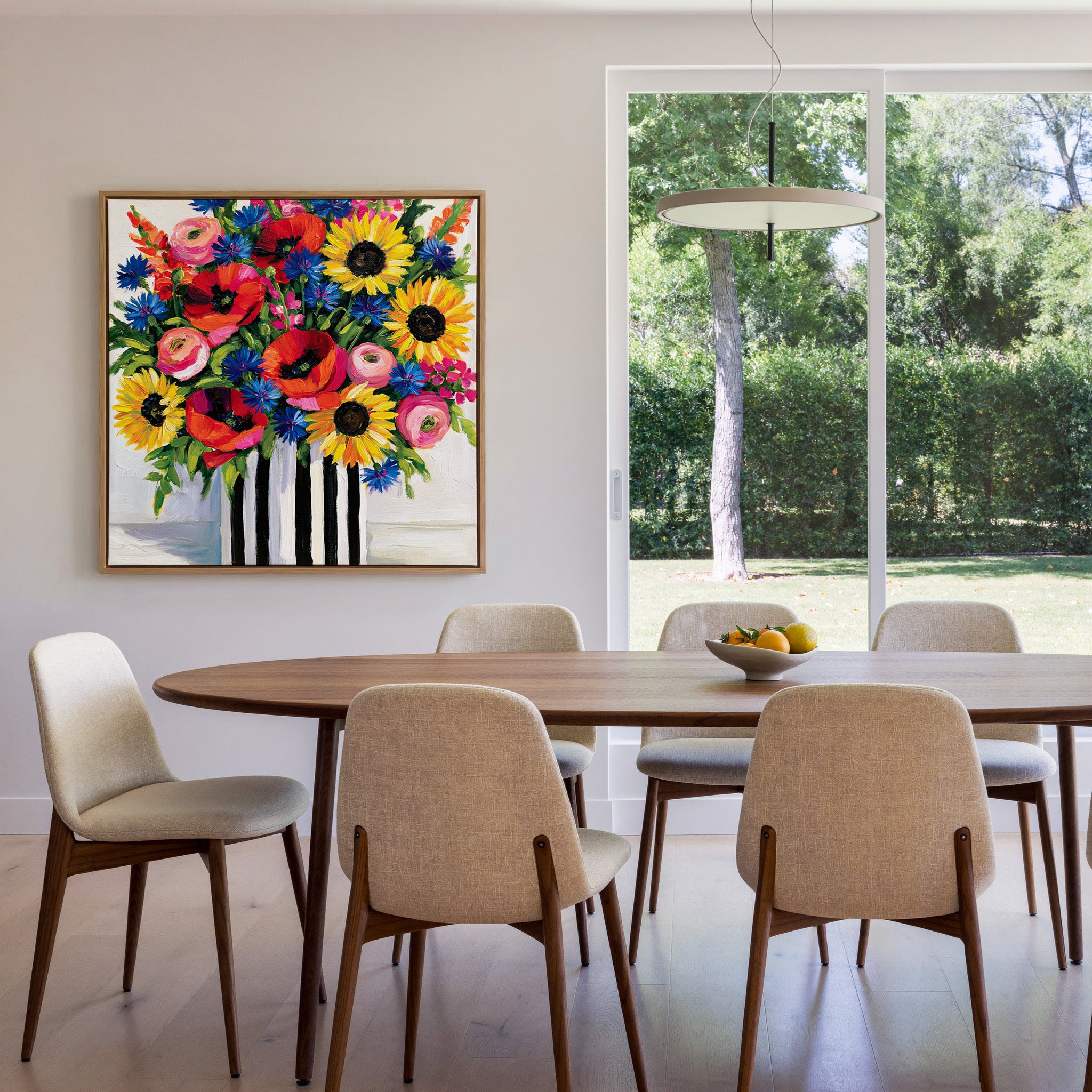 bright wildflower bouquet with poppies, canvas wall art in an oak frame in a dining room