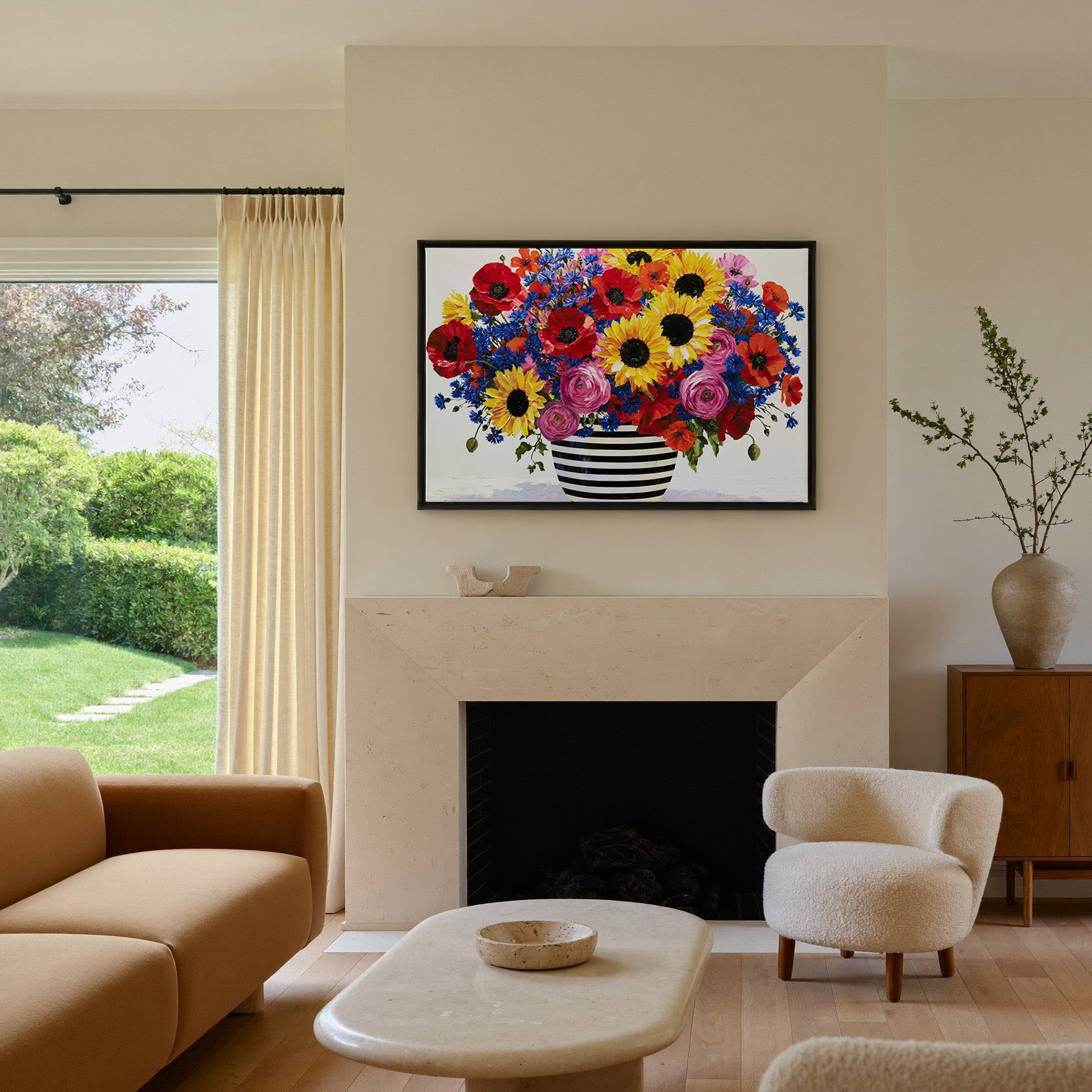 colorful bouquet with striped vase canvas wall art in a black frame above a mantel