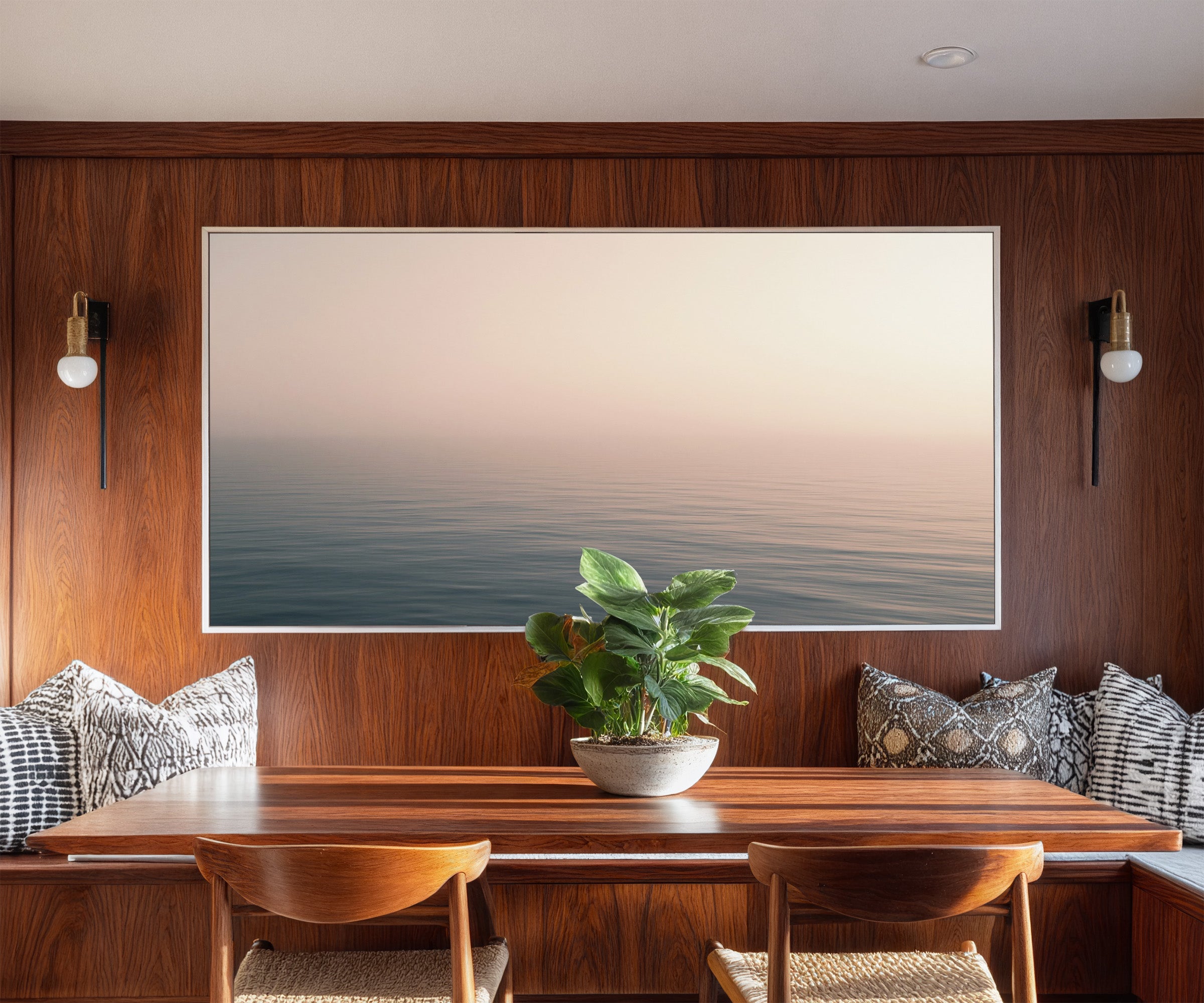 soft blush and blue seascape canvas wall art in a white frame in a styled room setting