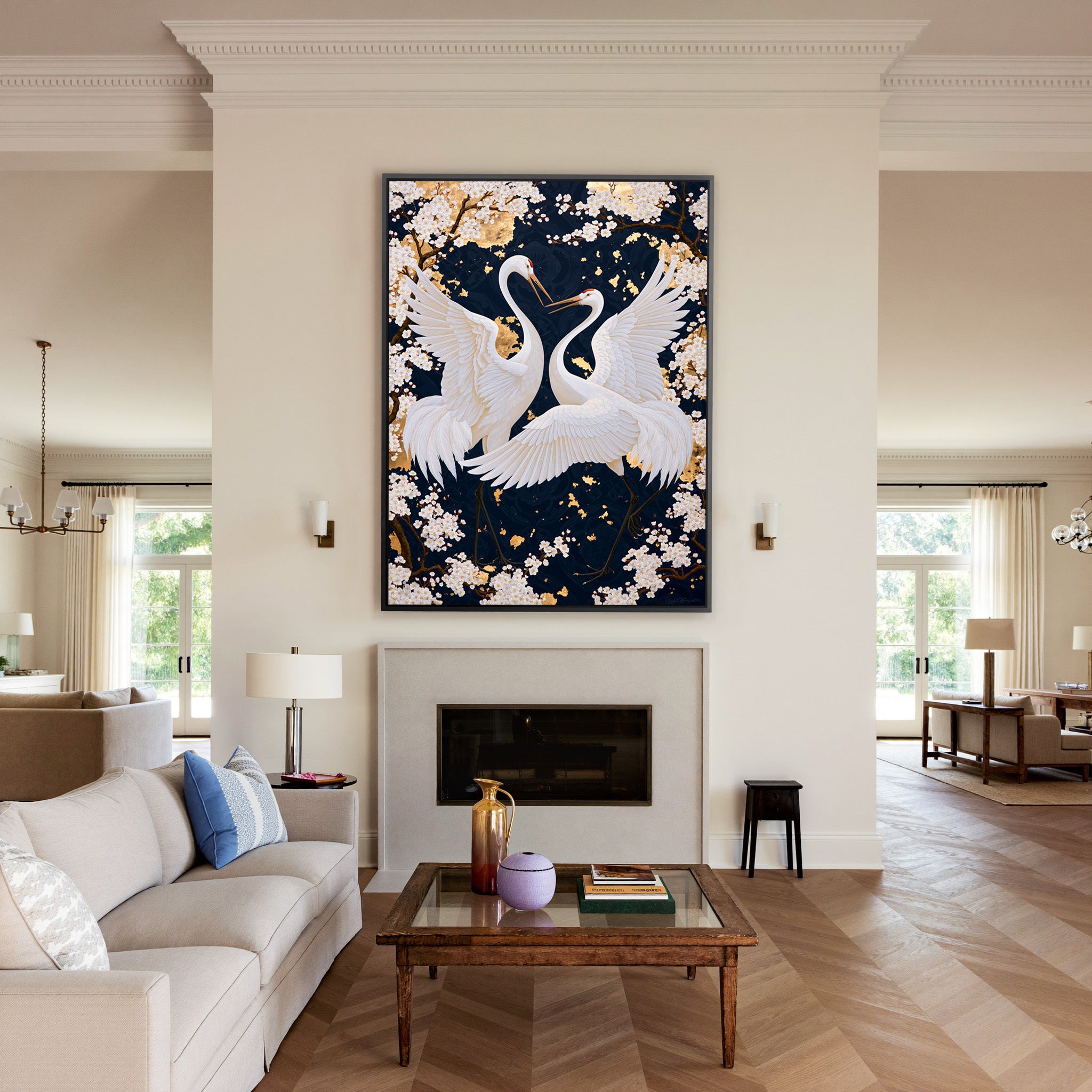 white crane pair among cherry blossoms on a canvas wall art in a black frame above a mantel
