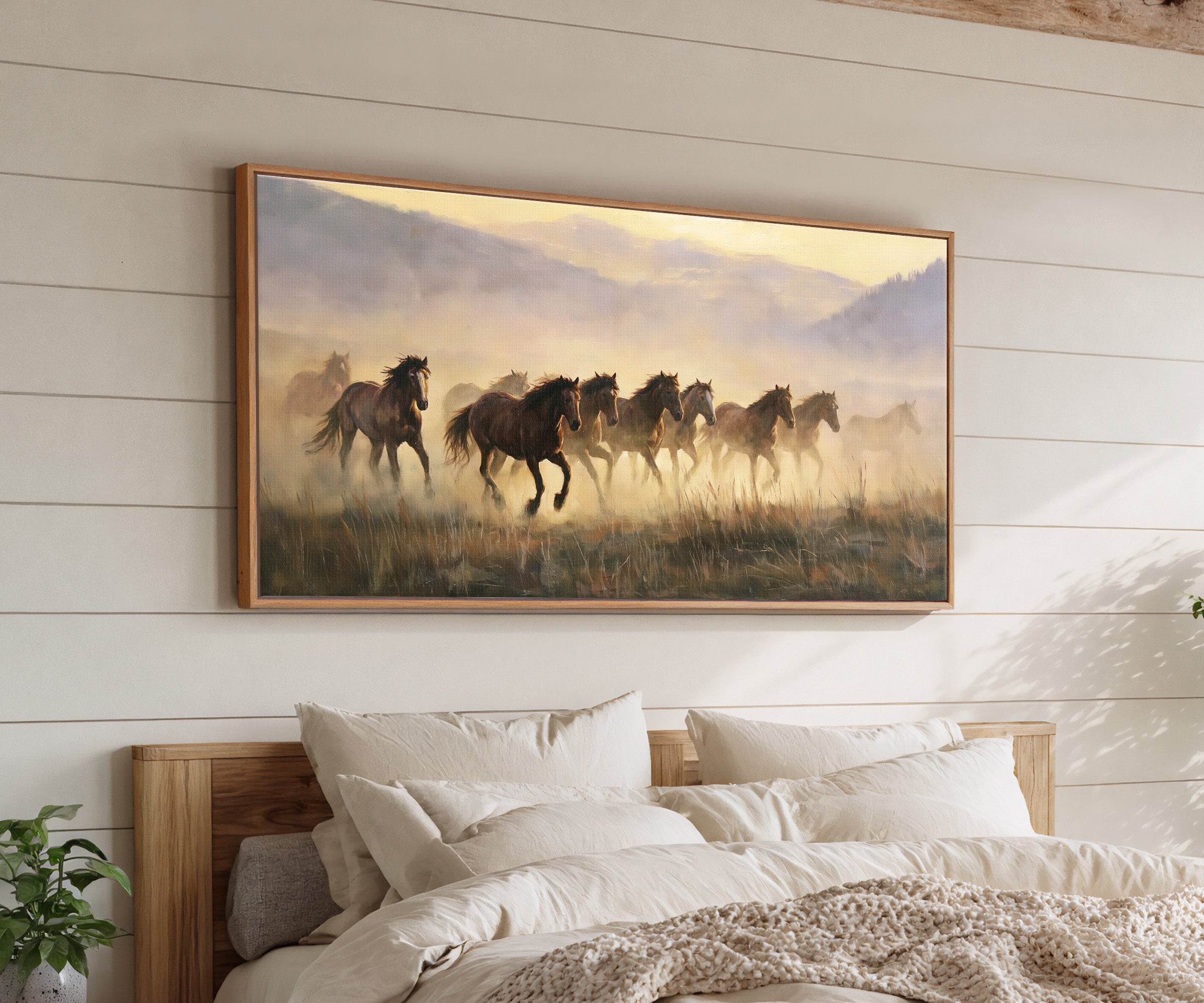 misty mustang herd at sunrise canvas wall art in an oak frame above a bed