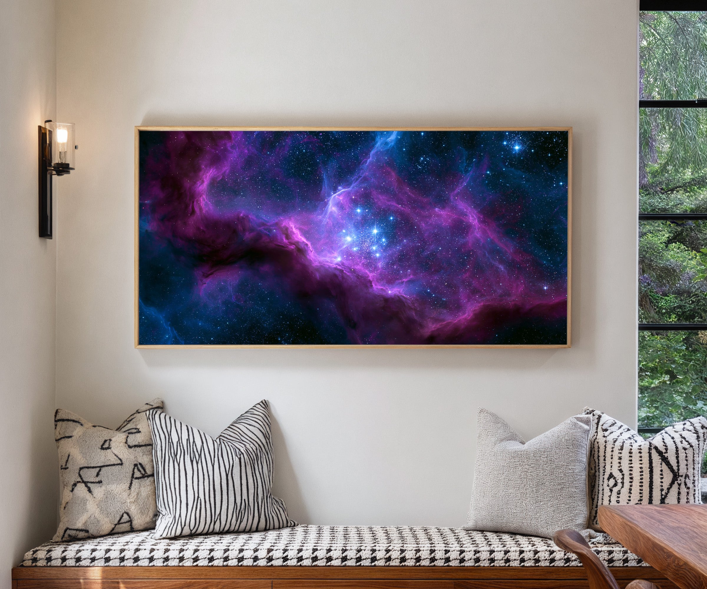 violet and blue nebula with bright star cluster canvas wall art in a natural wood frame in a living room