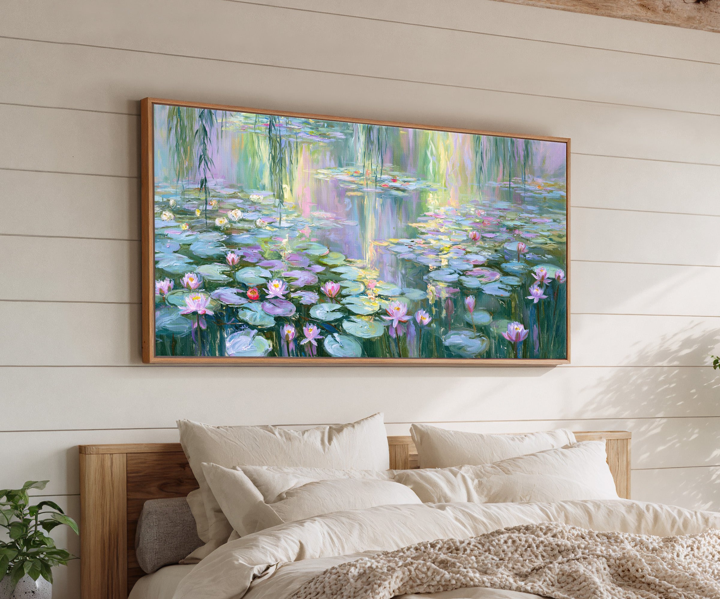 pastel water lily pond with reflected light canvas wall art in an oak frame above a bed