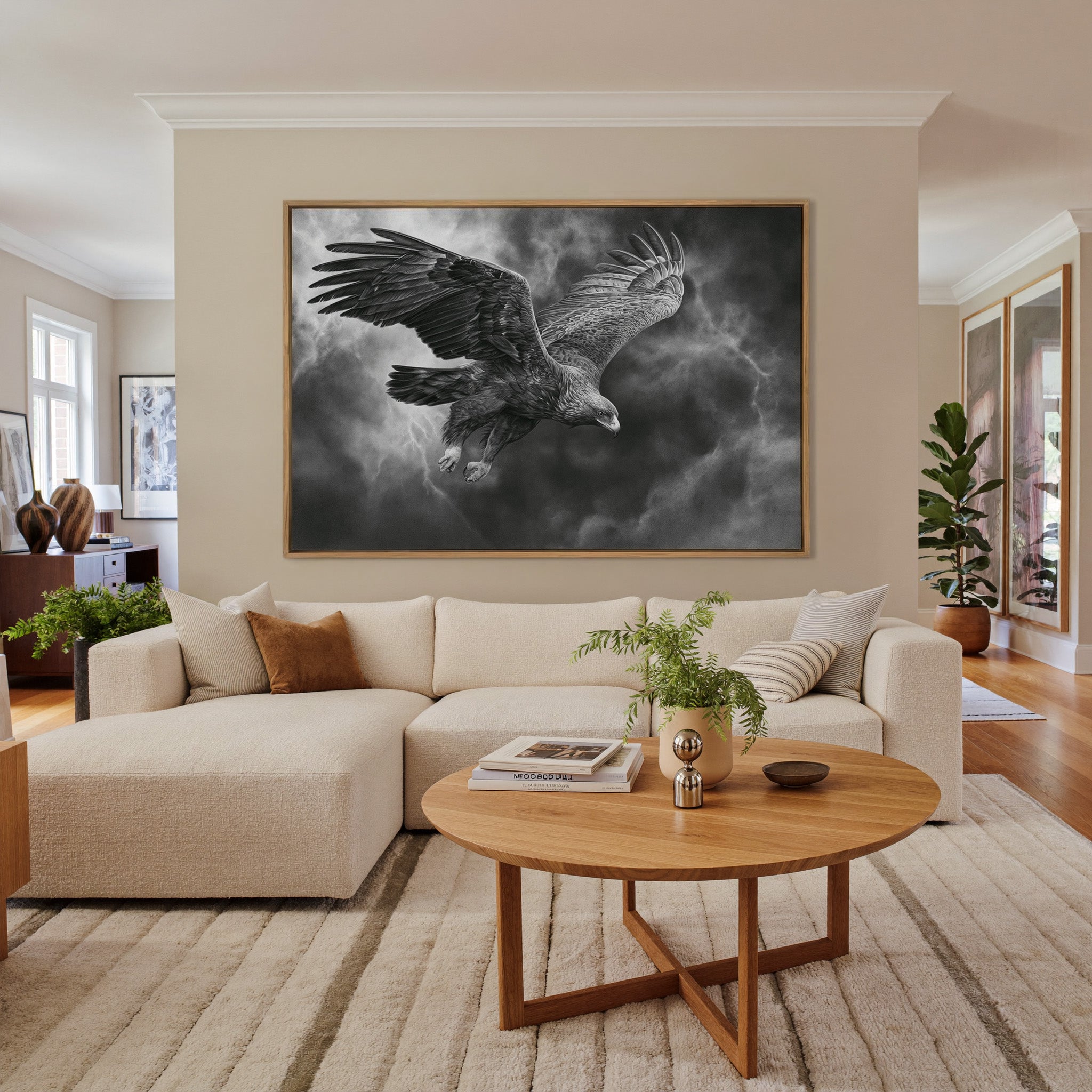 golden eagle in a steep dive through storm canvas wall art in an oak frame in a living room