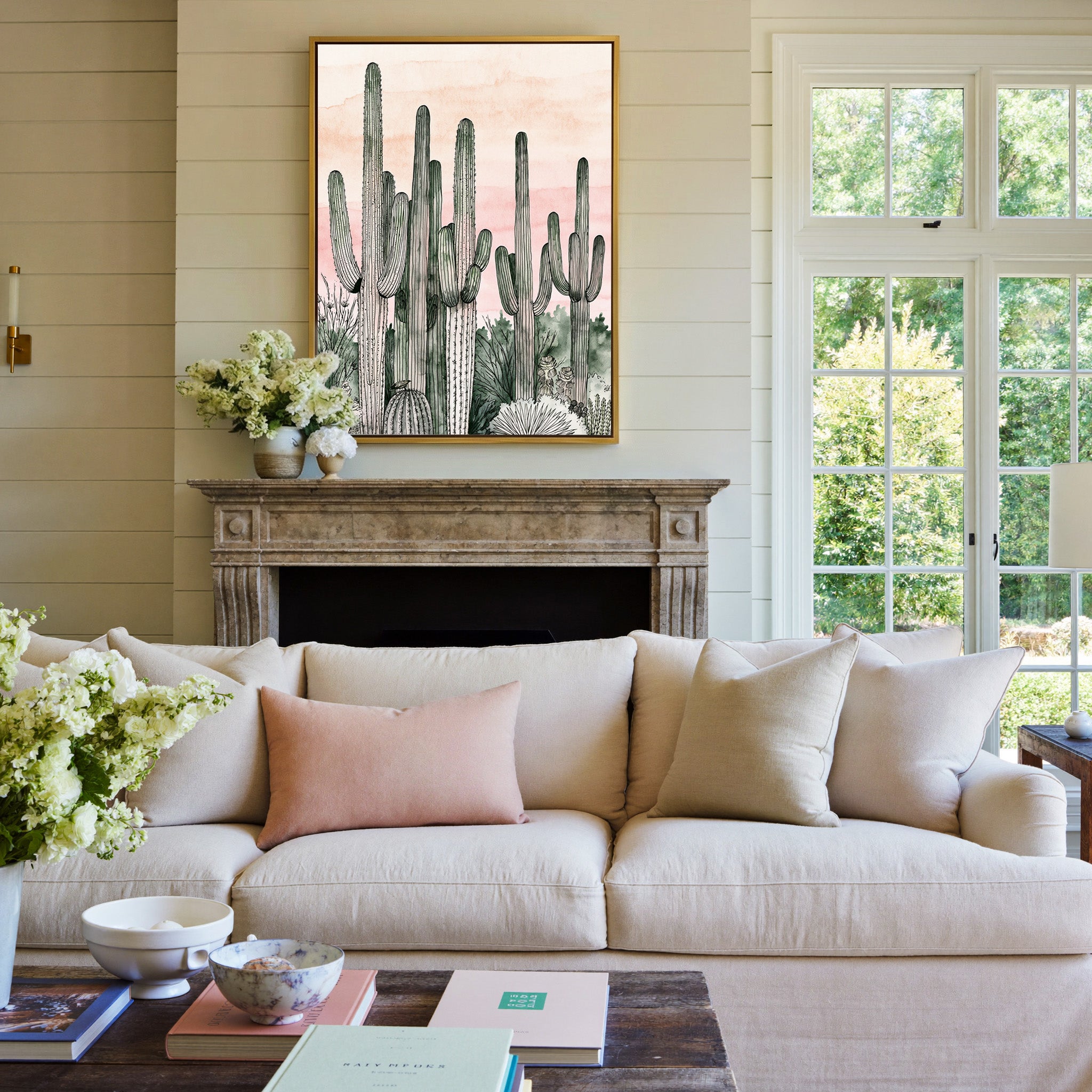 pink dusk sky with tall saguaro columns canvas wall art in a gold frame above a mantel