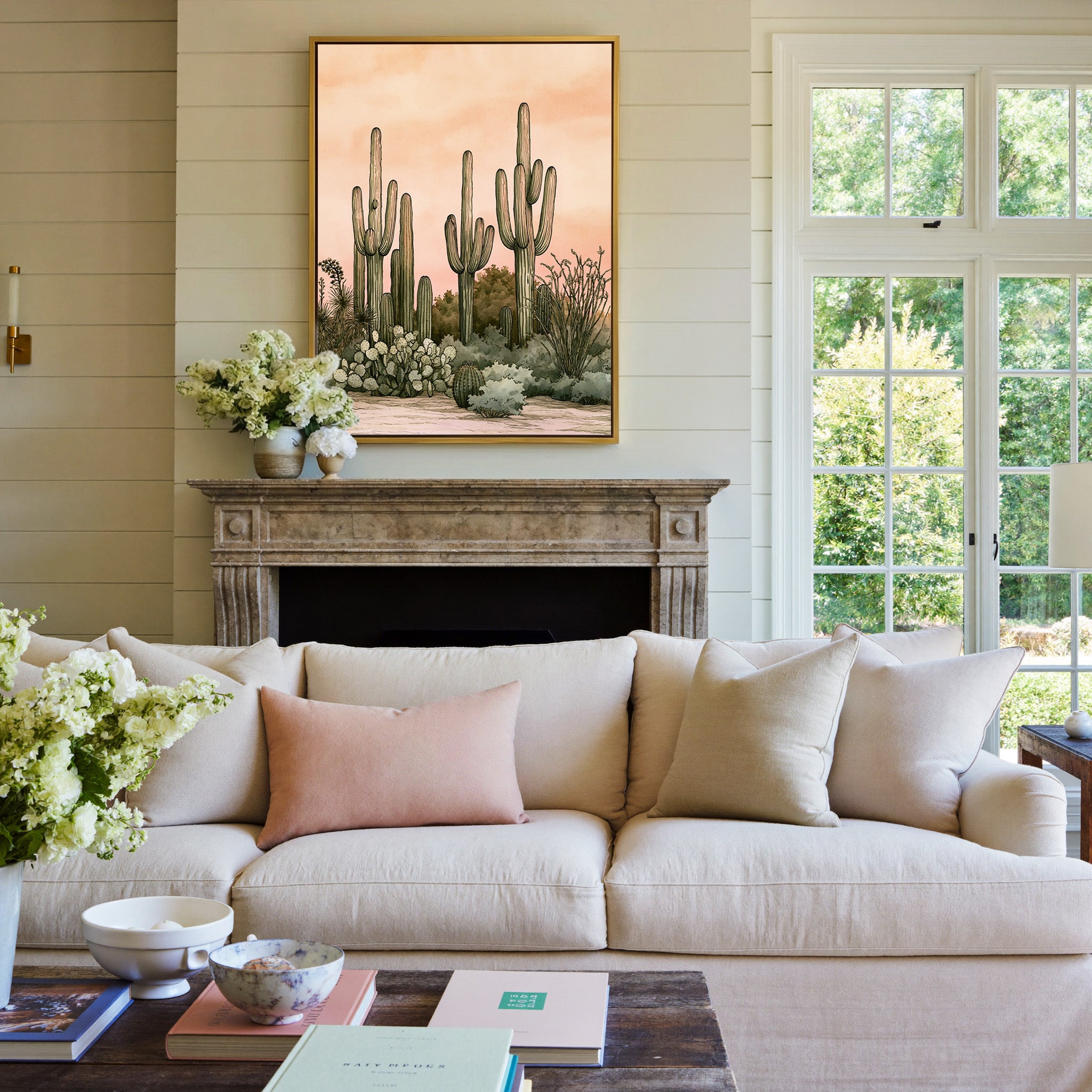 pink dusk desert cactus garden canvas wall art in a gold frame above a mantel