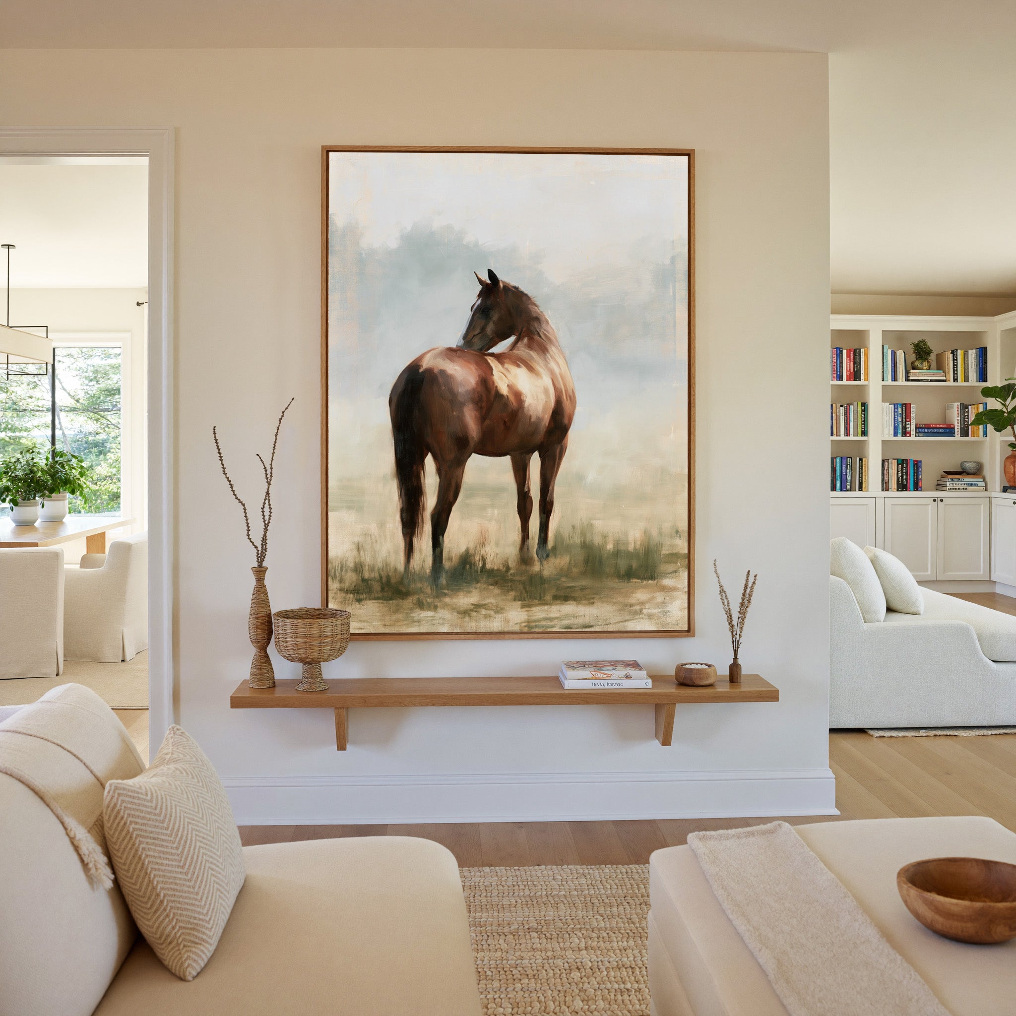 single chestnut horse in a pale open field canvas wall art in an oak frame in a living room