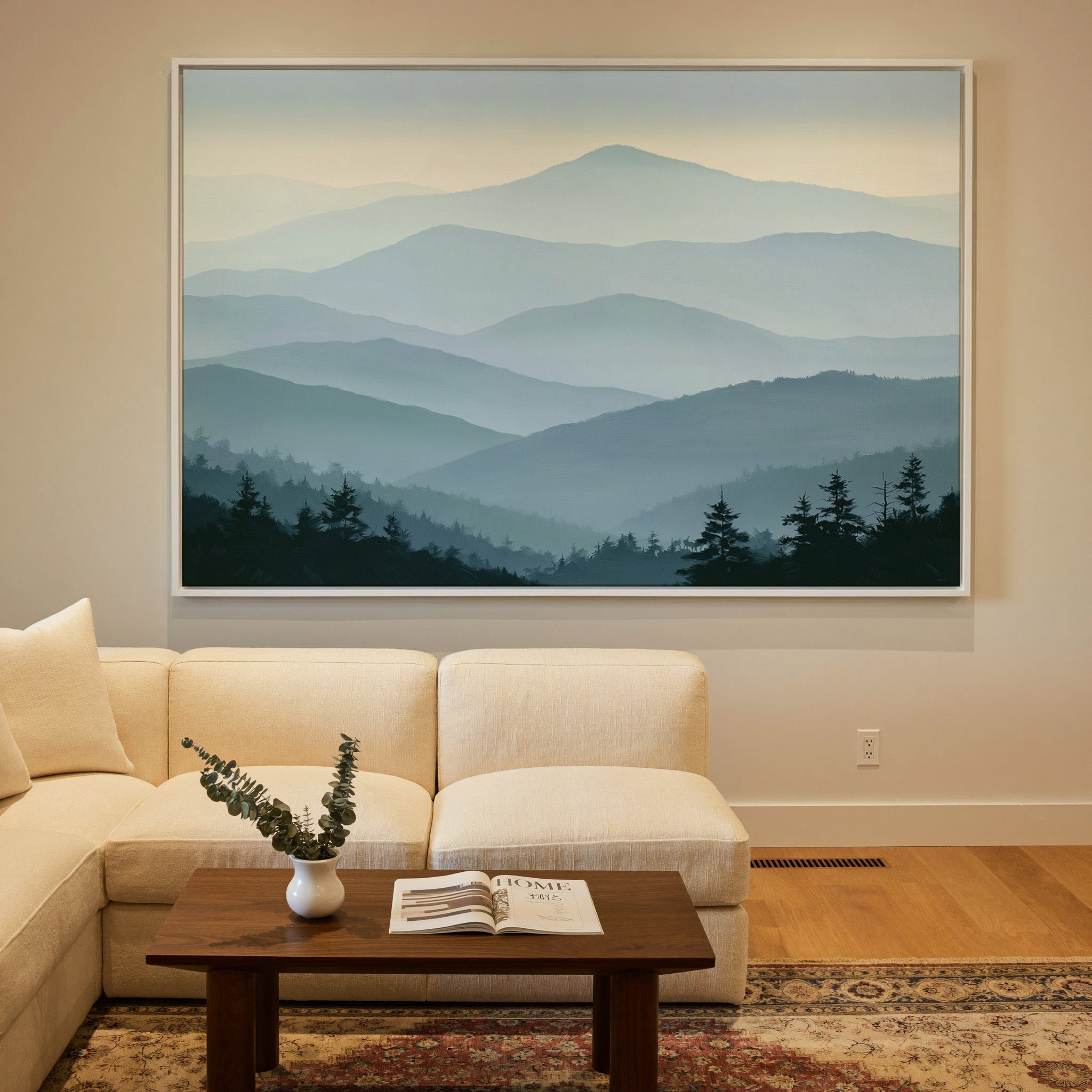 layered blue mountain ridges with mist and dark canvas wall art in a white frame in a styled room setting
