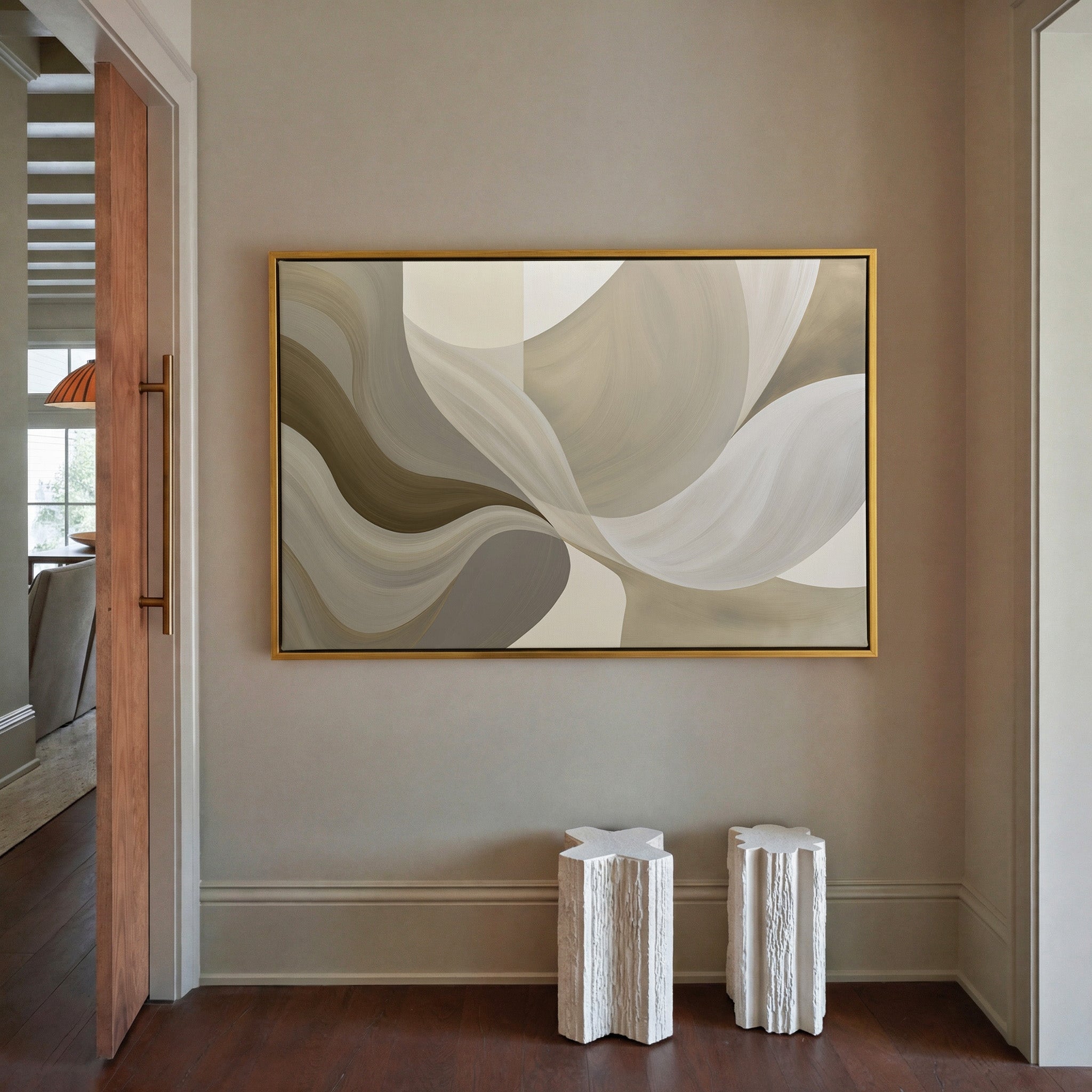 neutral abstract with large sweeping cream, canvas wall art in a gold frame in a styled room setting