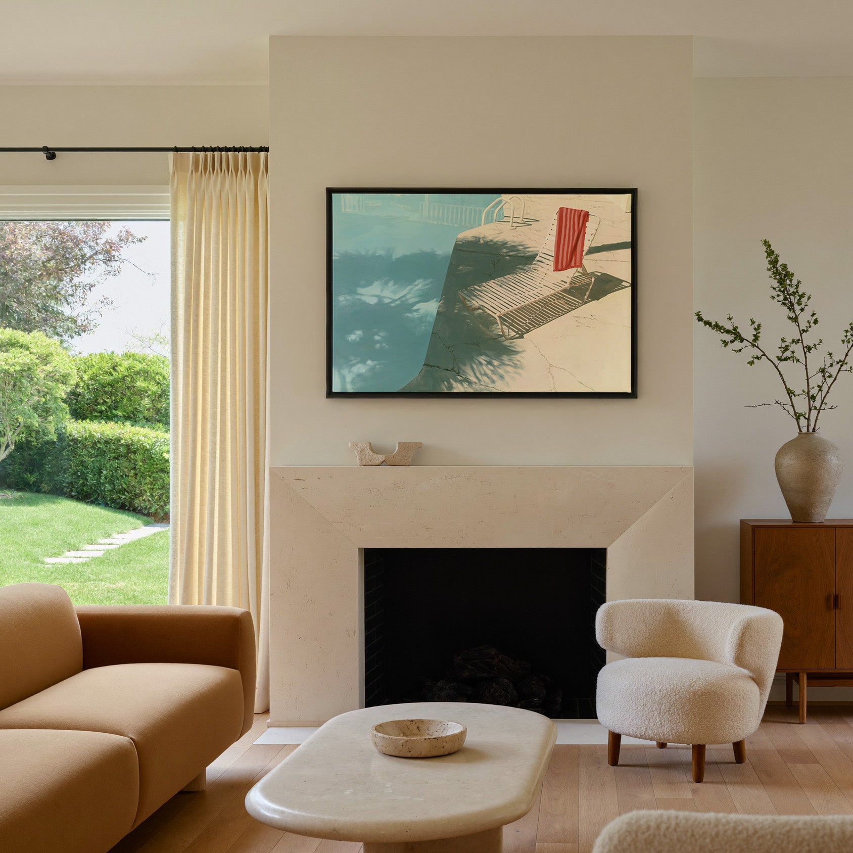 sunlit turquoise pool with striped lounge chair canvas wall art in a black frame above a mantel