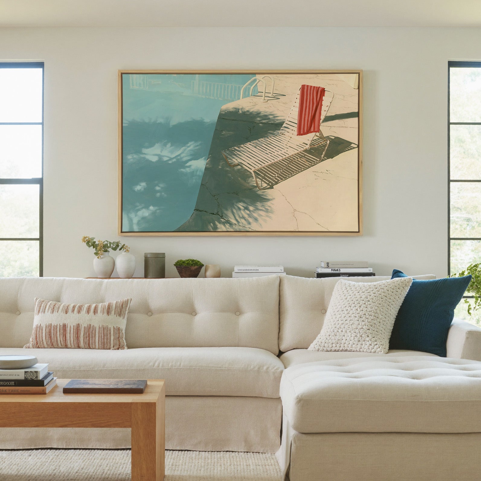 sunlit turquoise pool with striped lounge chair canvas wall art in a natural wood frame in a living room