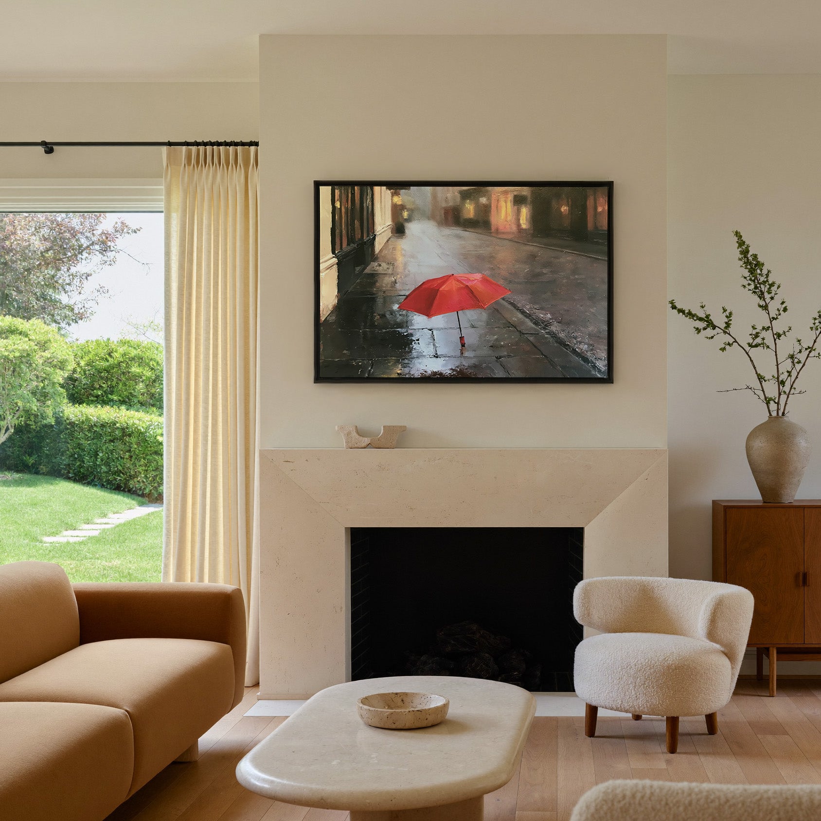 small red umbrella on a wet sidewalk canvas wall art in a black frame above a mantel