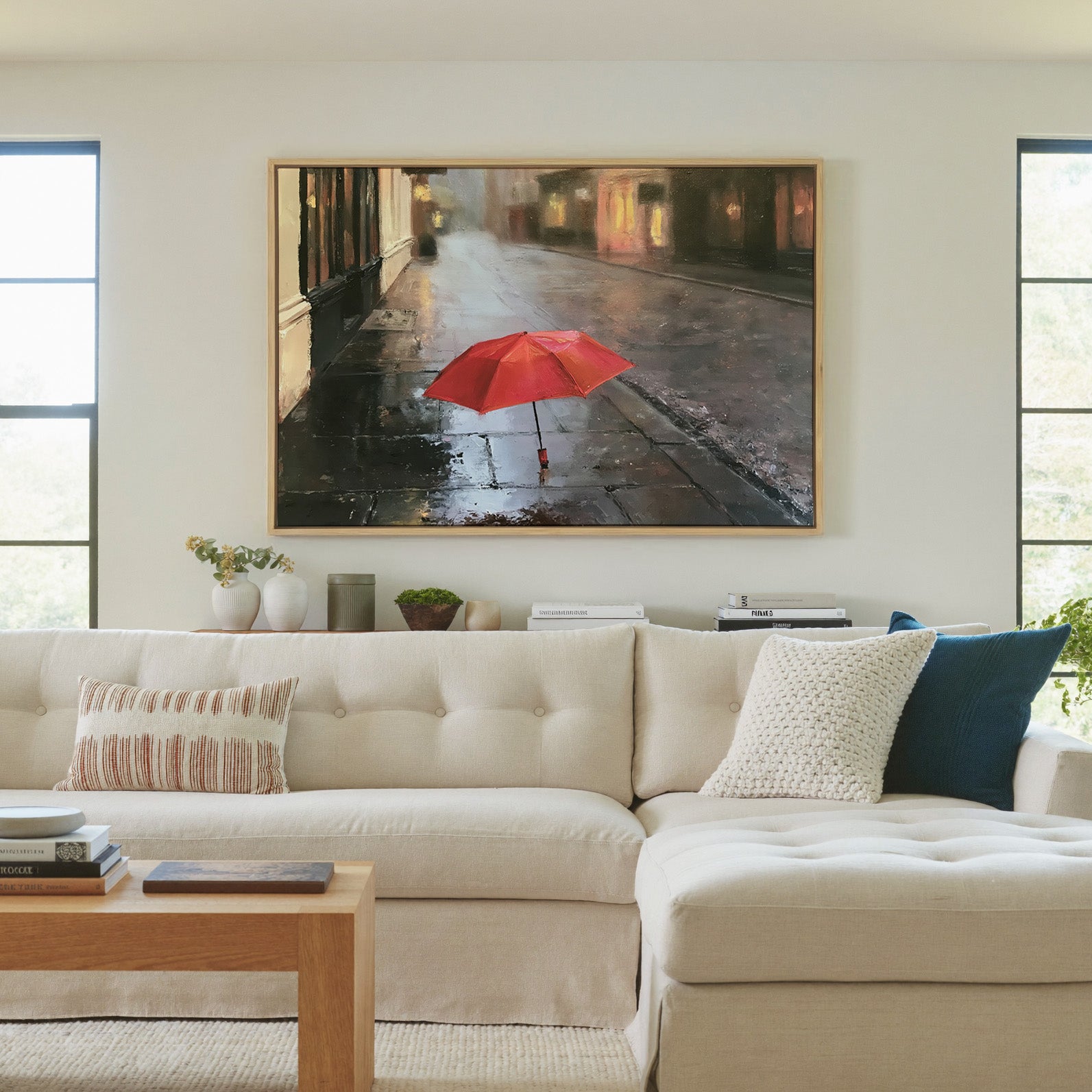 small red umbrella on a wet sidewalk canvas wall art in a natural wood frame in a living room