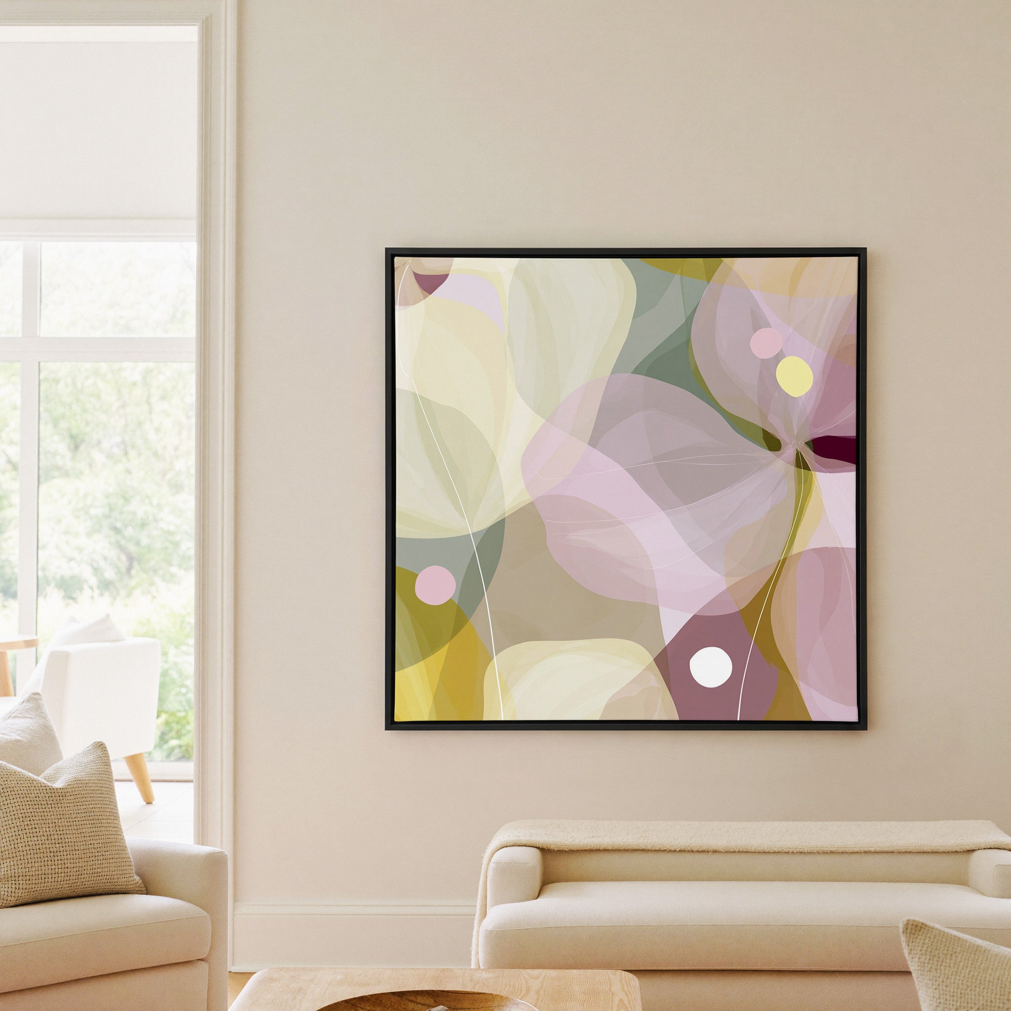 soft translucent petals in blush, cream, and canvas wall art in a black frame in a living room