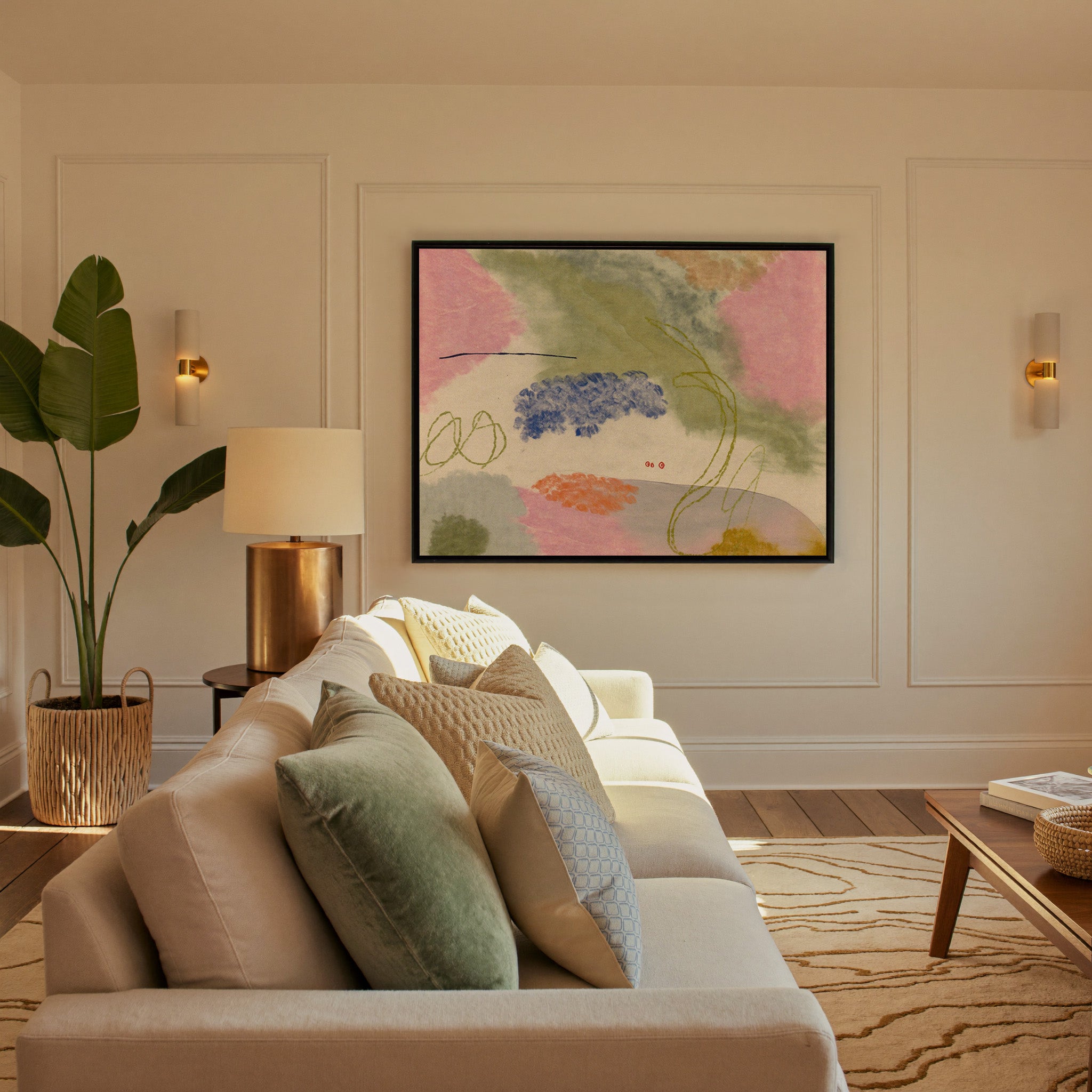 soft pink, green, blue, and orange abstract canvas wall art in a black frame in a styled room setting