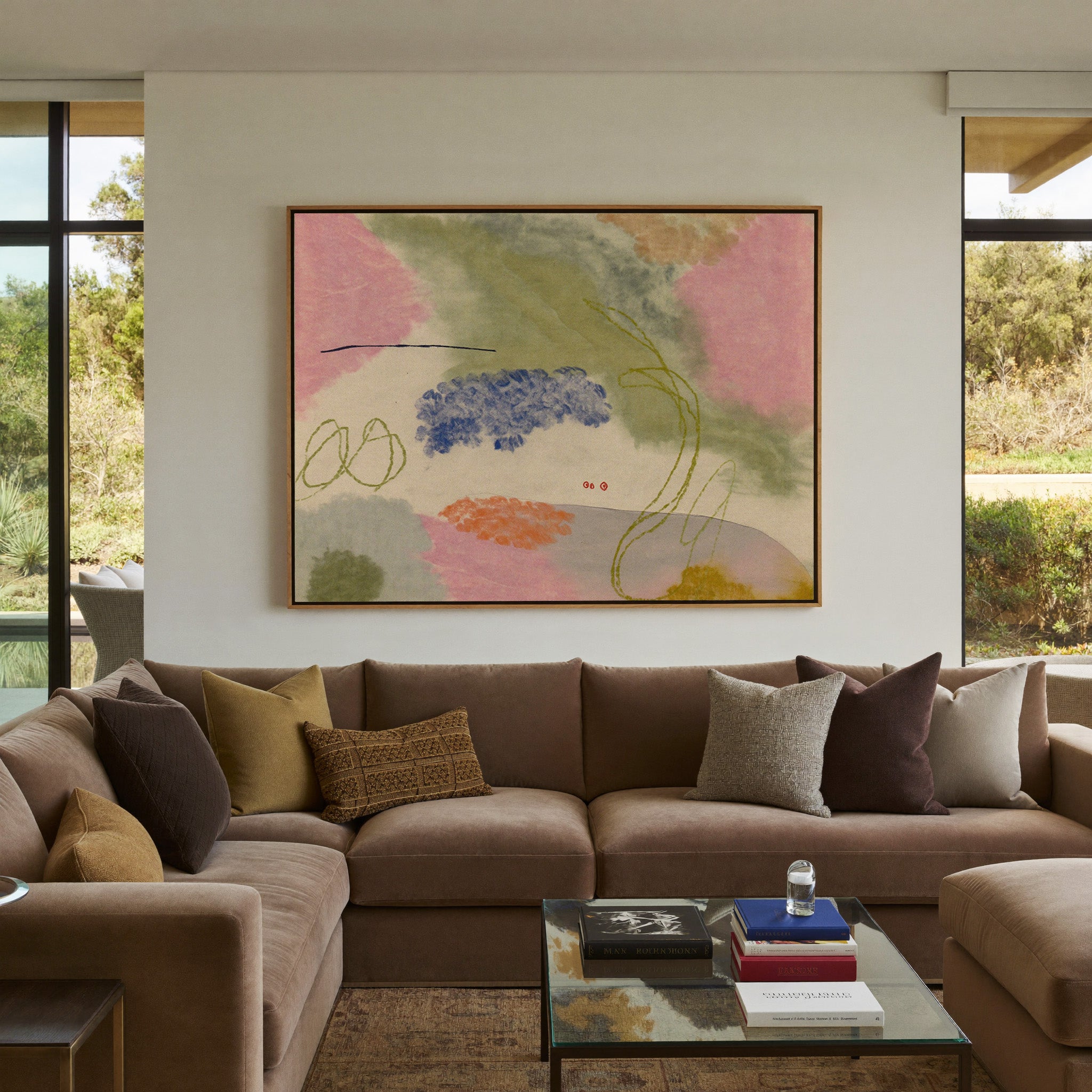 soft pink, green, blue, and orange abstract canvas wall art in an oak frame in a styled room setting