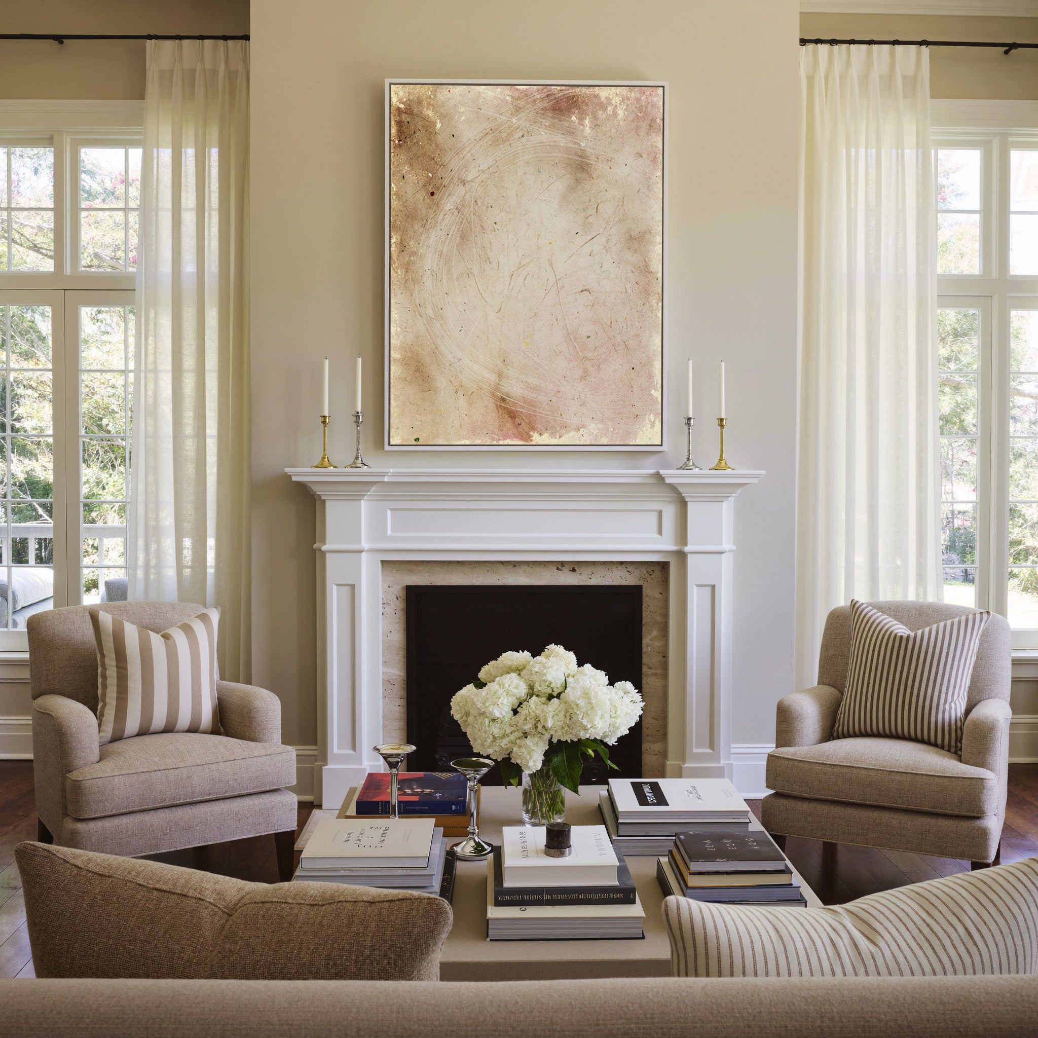 warm beige abstract with pale curved lines canvas wall art in a white frame above a mantel