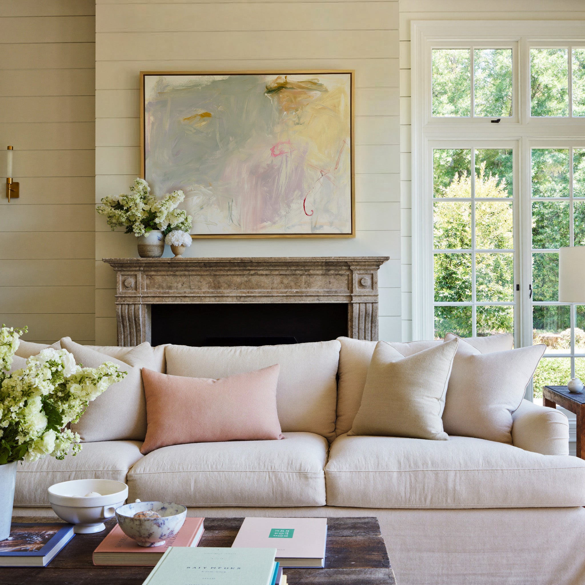 pale cream, blush, and sage abstract canvas wall art in a gold frame above a mantel