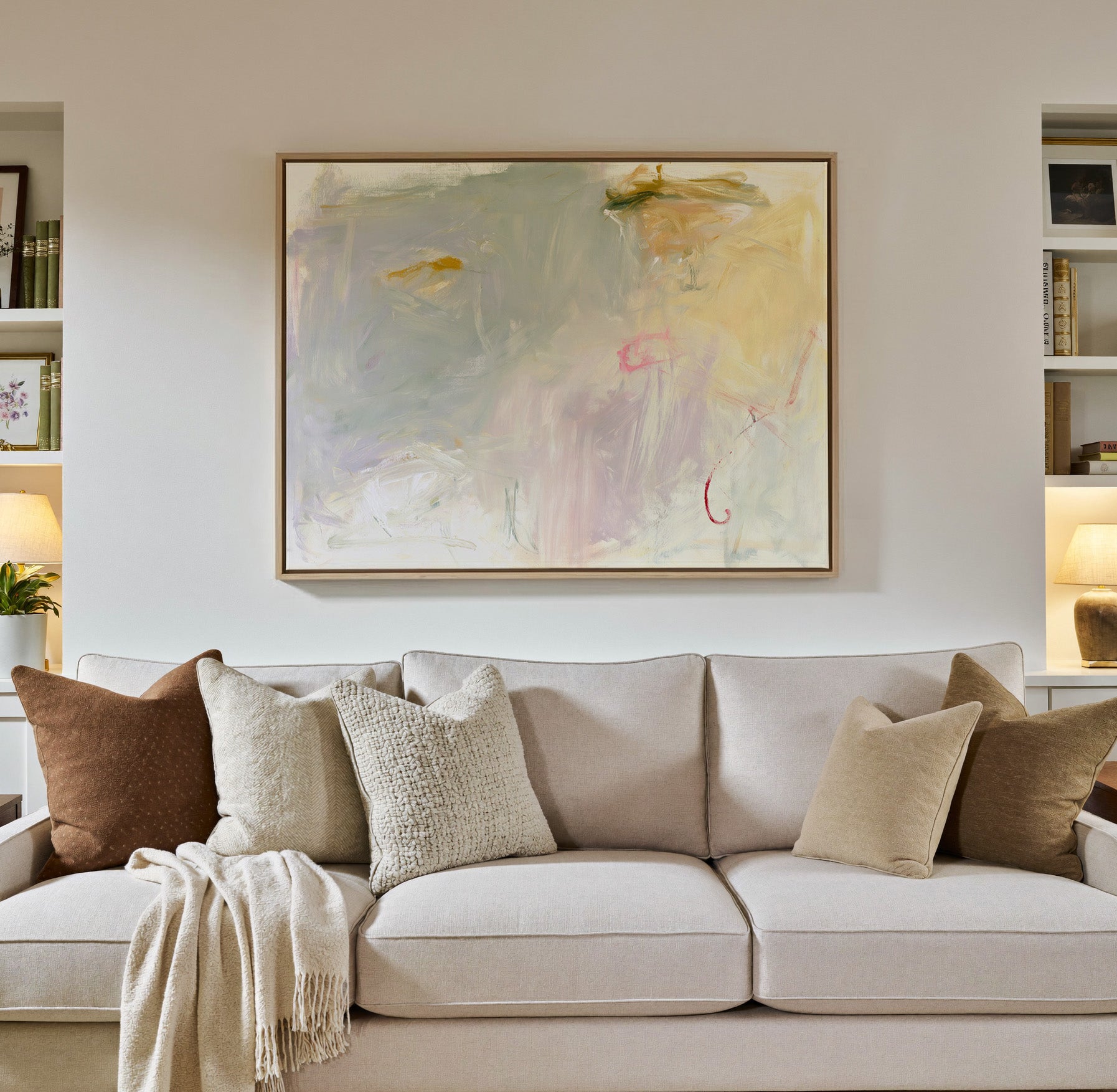 pale cream, blush, and sage abstract canvas wall art in a natural wood frame in a styled room setting