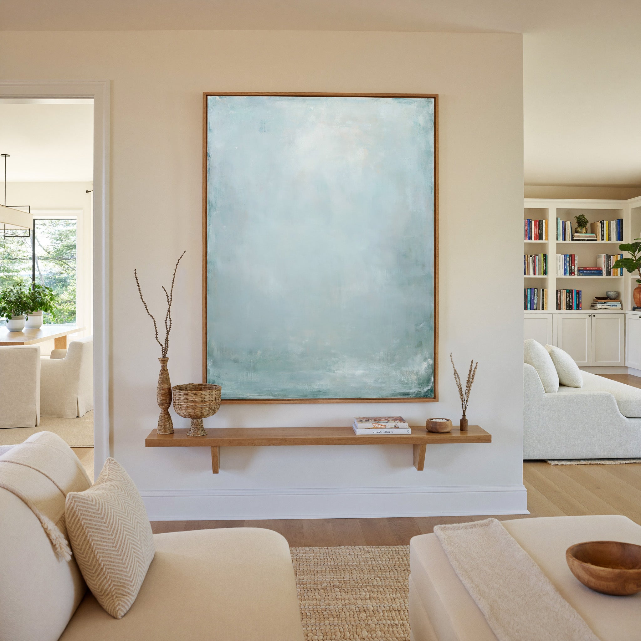 pale blue and white abstract with soft vertical canvas wall art in an oak frame in a living room