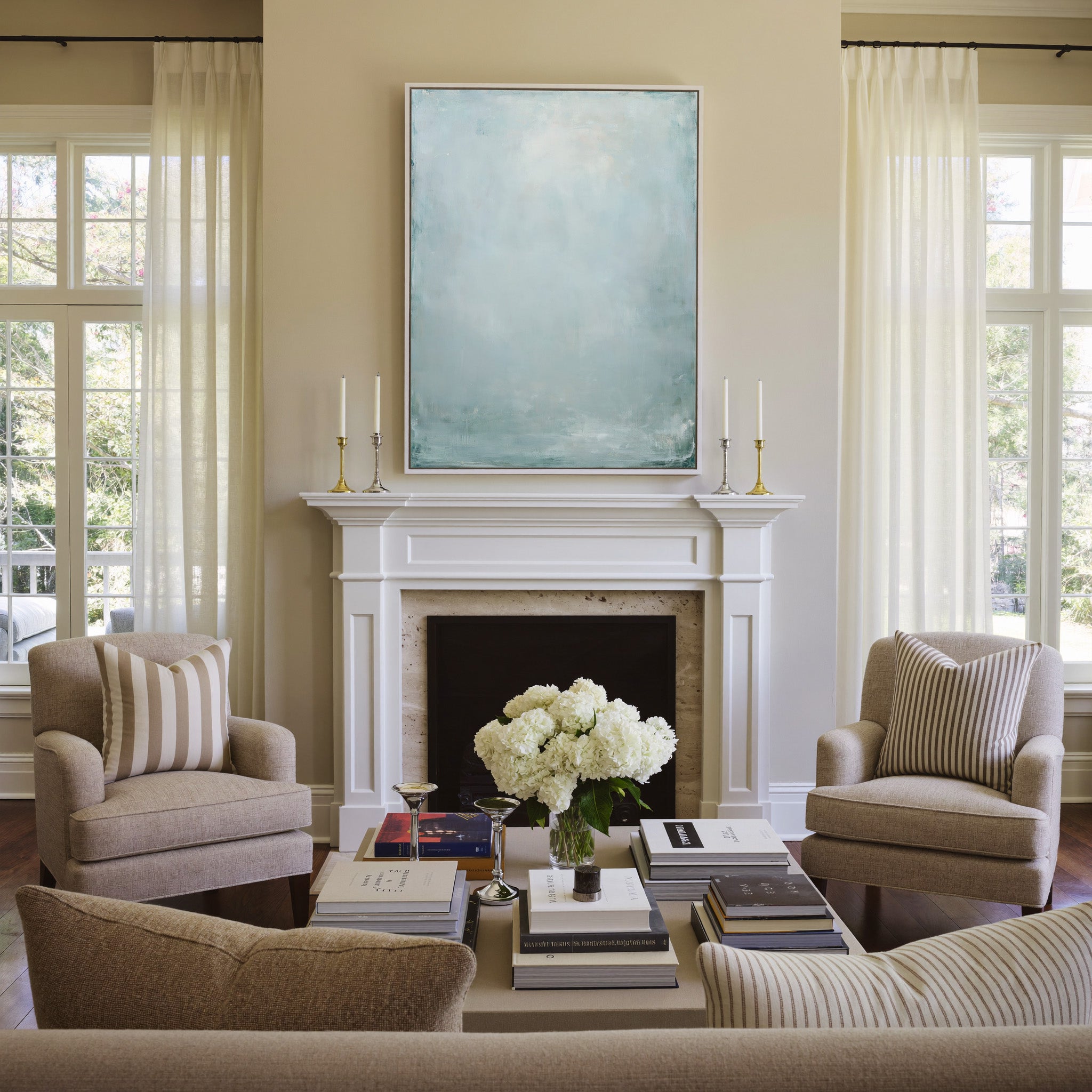 pale blue and white abstract with soft vertical canvas wall art in a white frame above a mantel