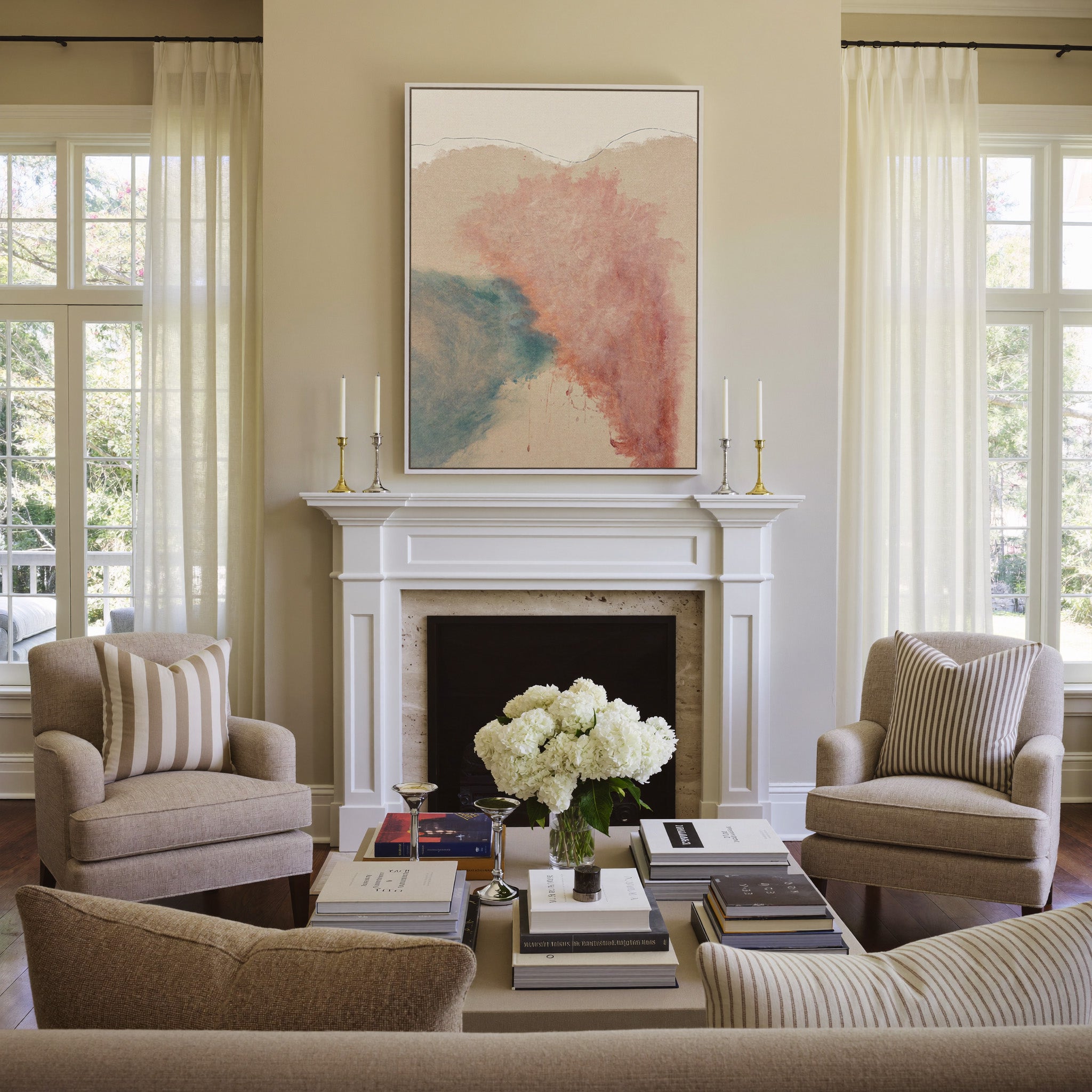 blush pink and teal abstract with soft clouded canvas wall art in a white frame above a mantel