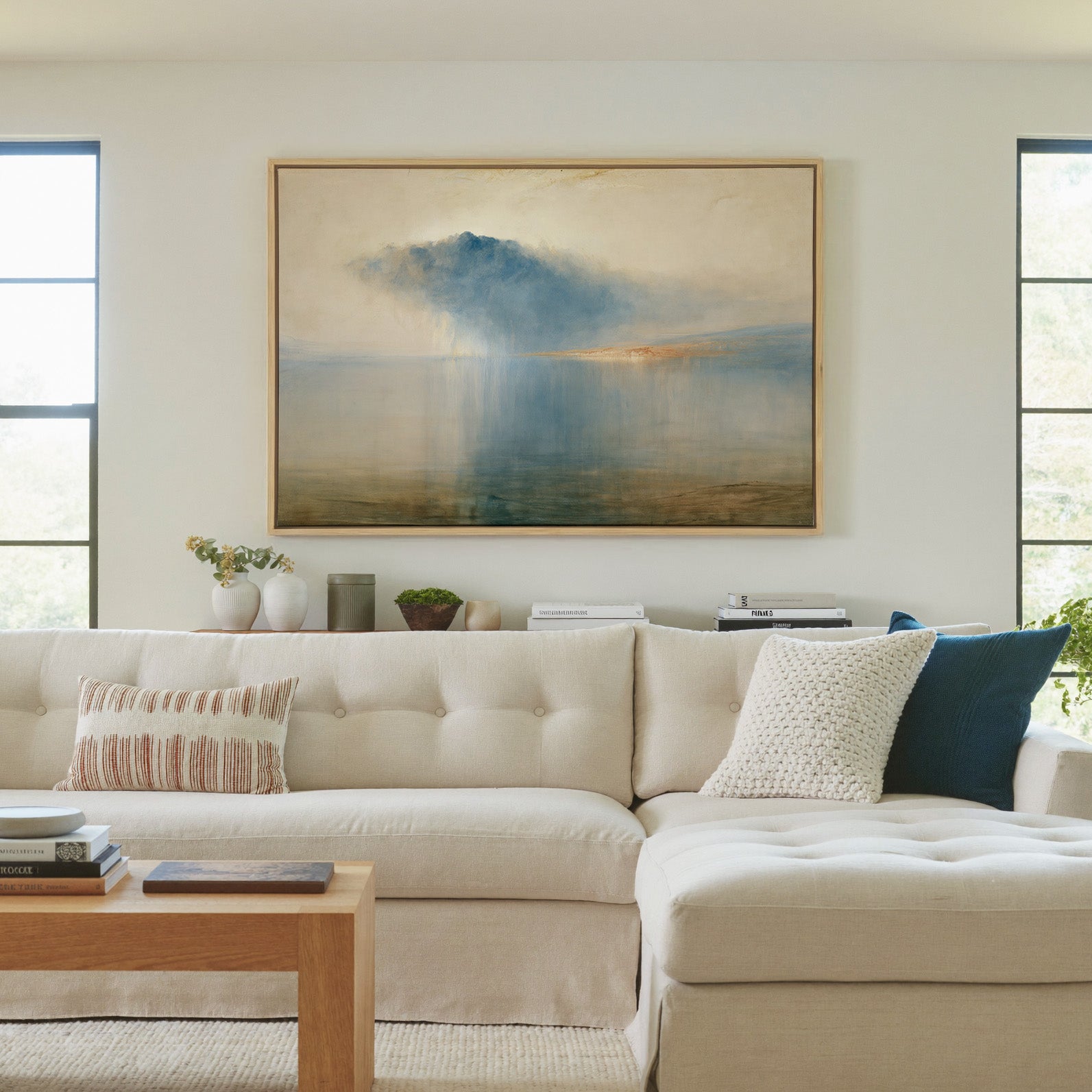 blue storm cloud over still water canvas wall art in a natural wood frame in a living room