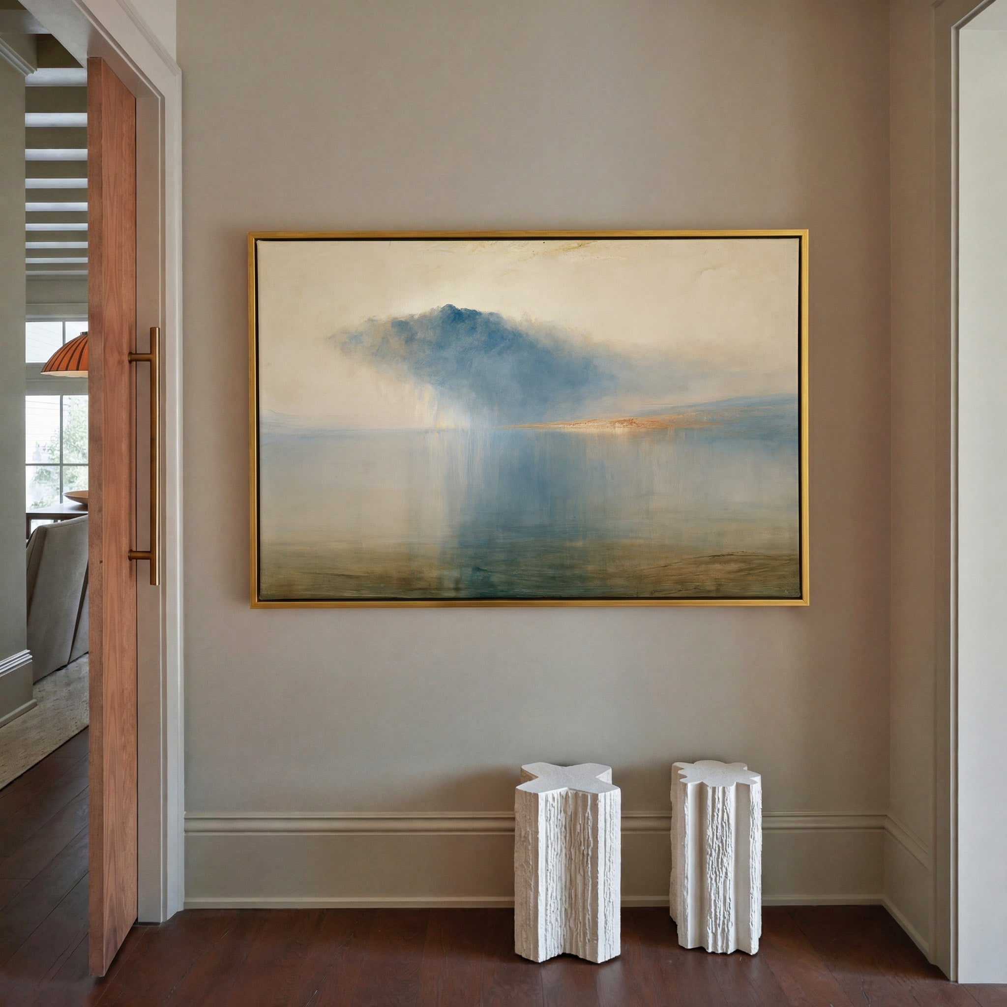 blue storm cloud over still water canvas wall art in a gold frame in a styled room setting