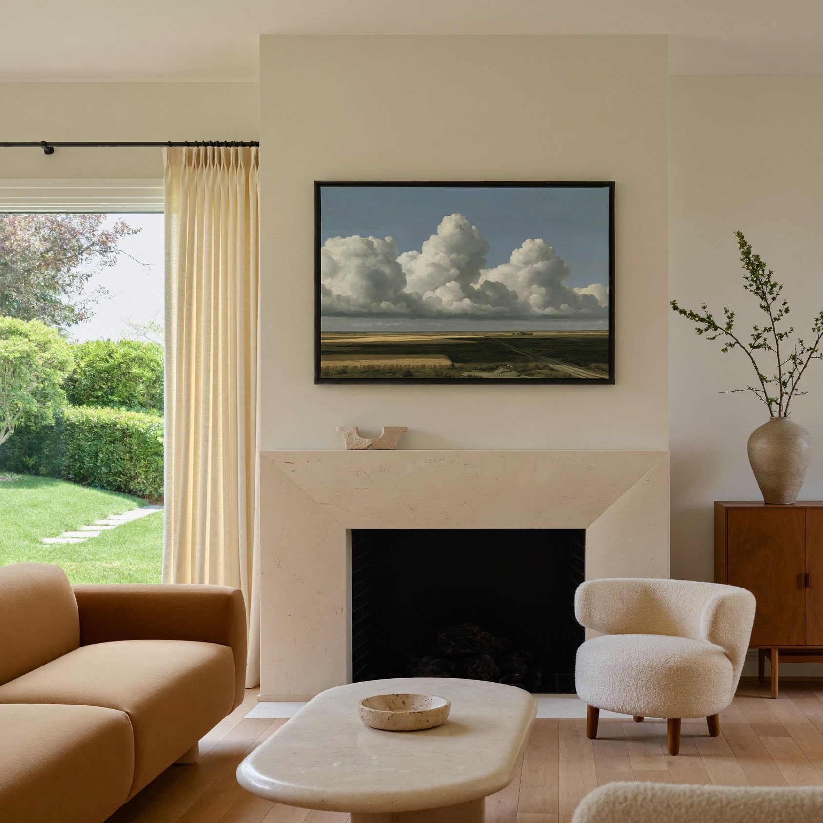 vast blue sky over low patchwork fields canvas wall art in a black frame above a mantel