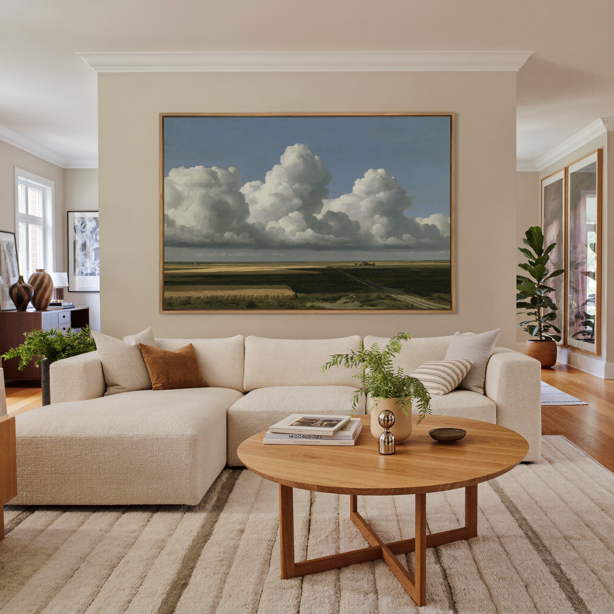 vast blue sky over low patchwork fields canvas wall art in an oak frame in a living room