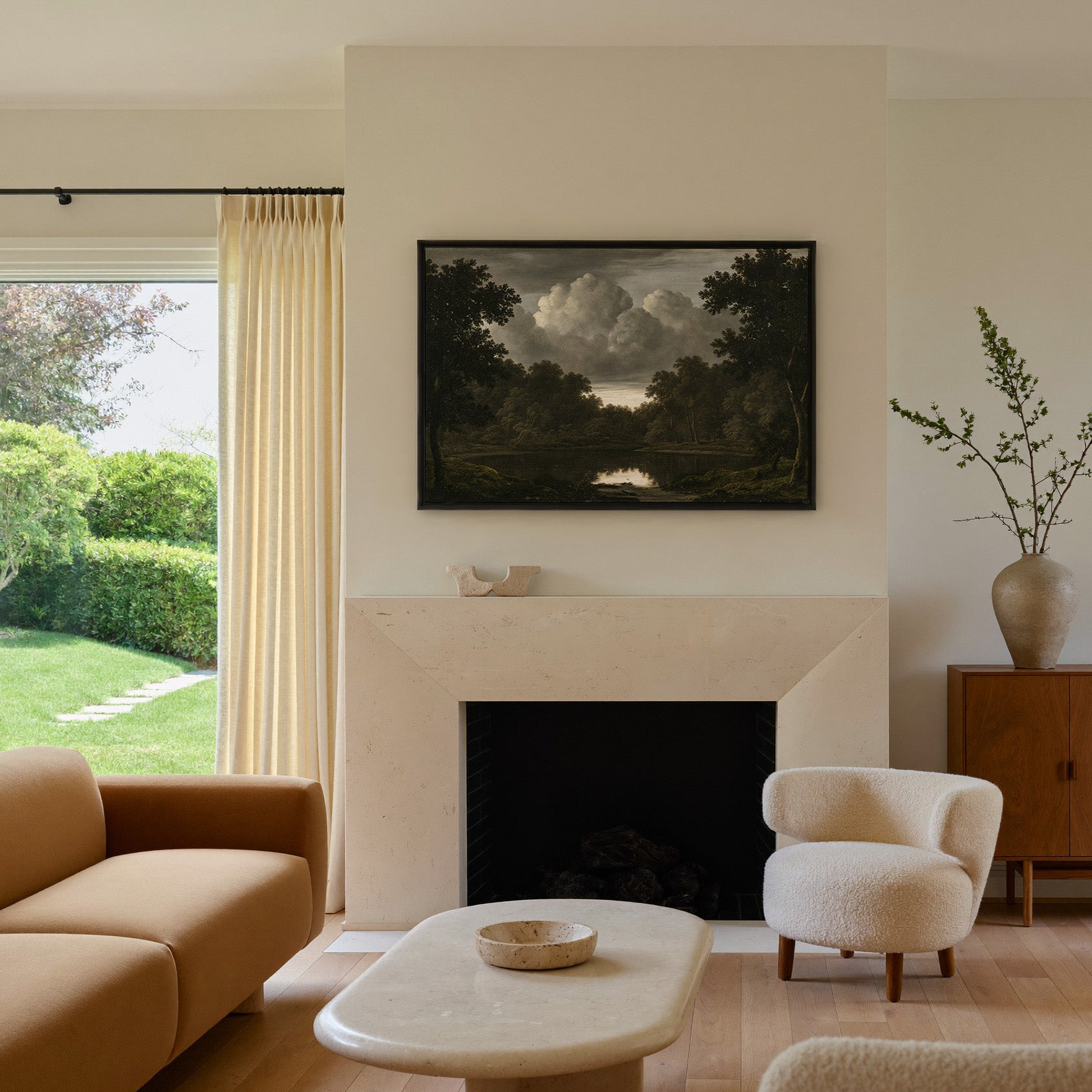 dark woodland pool beneath heavy storm clouds canvas wall art in a black frame above a mantel