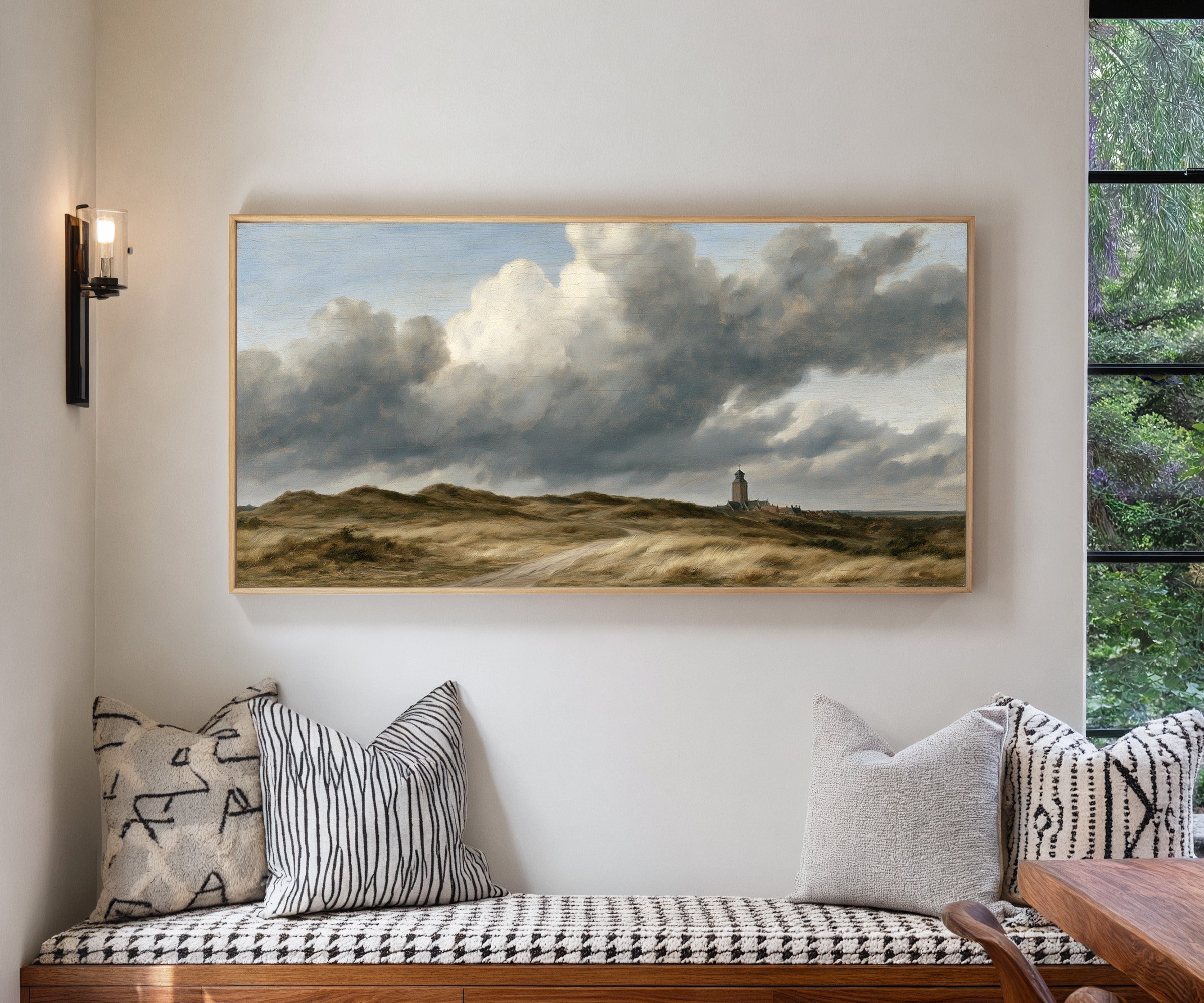 low dunes under towering wind driven clouds canvas wall art in a natural wood frame in a living room