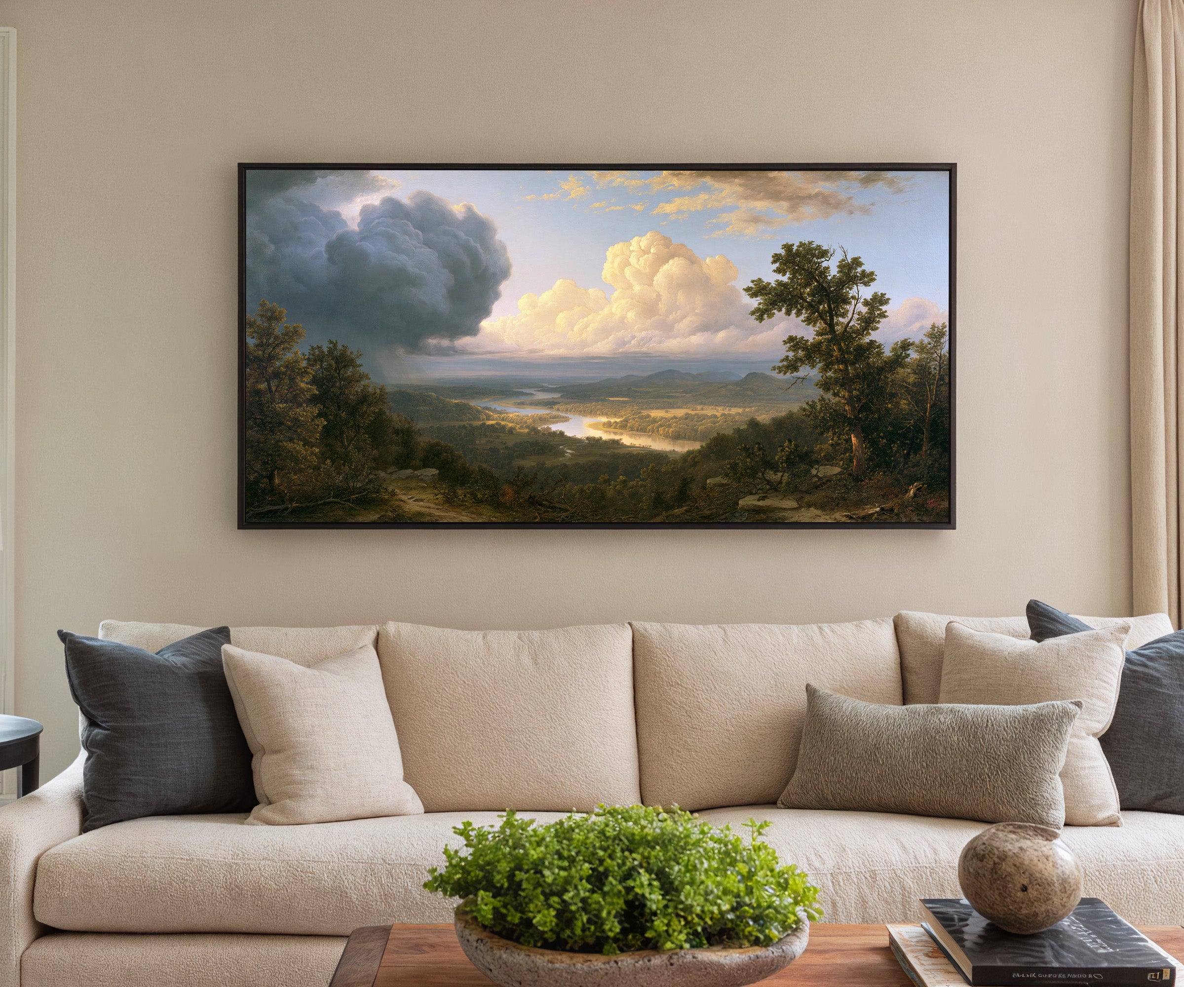 wide river valley with towering clouds canvas wall art in a black frame in a styled room setting