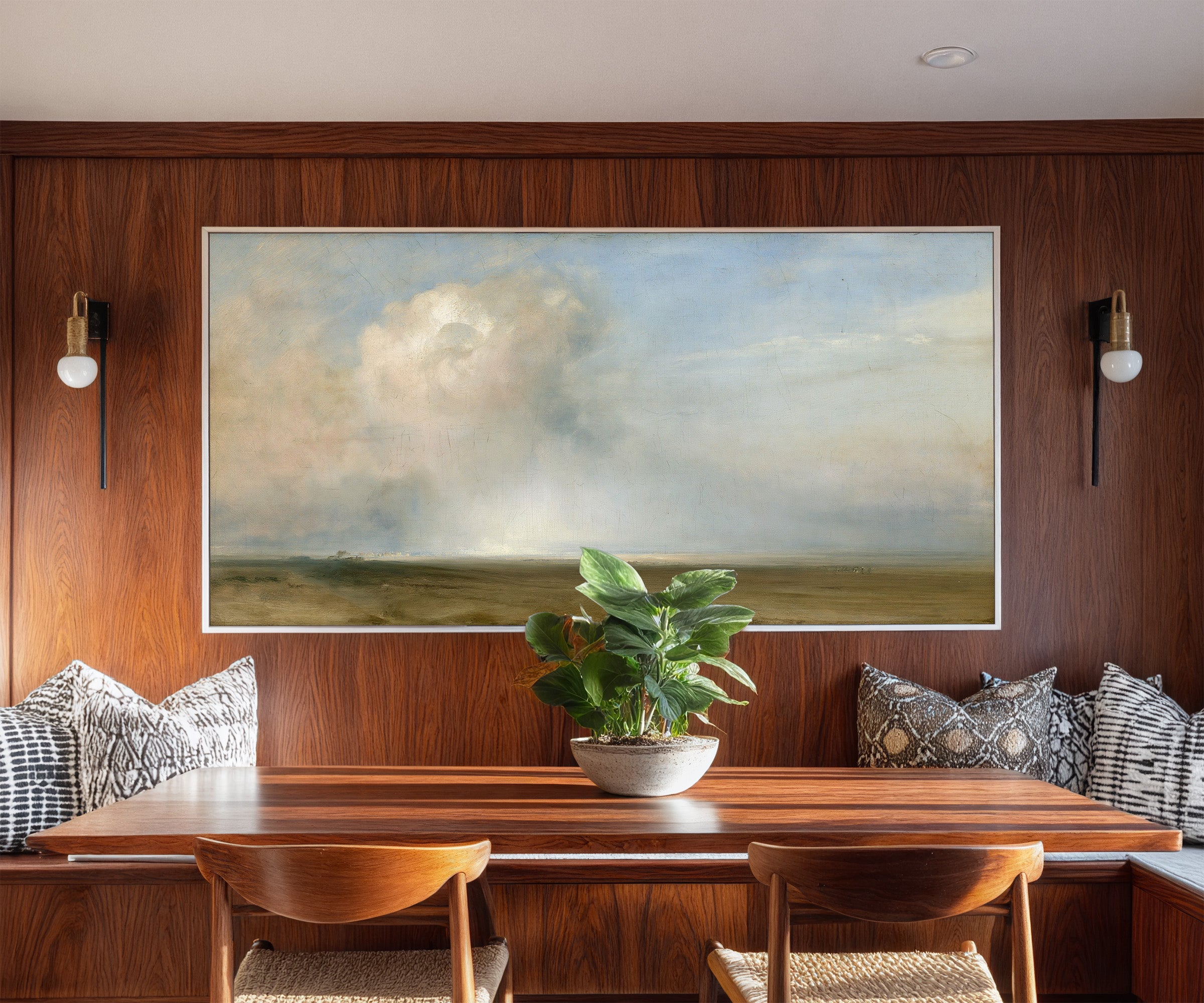 single towering cumulus cloud over a low plain canvas wall art in a white frame in a styled room setting