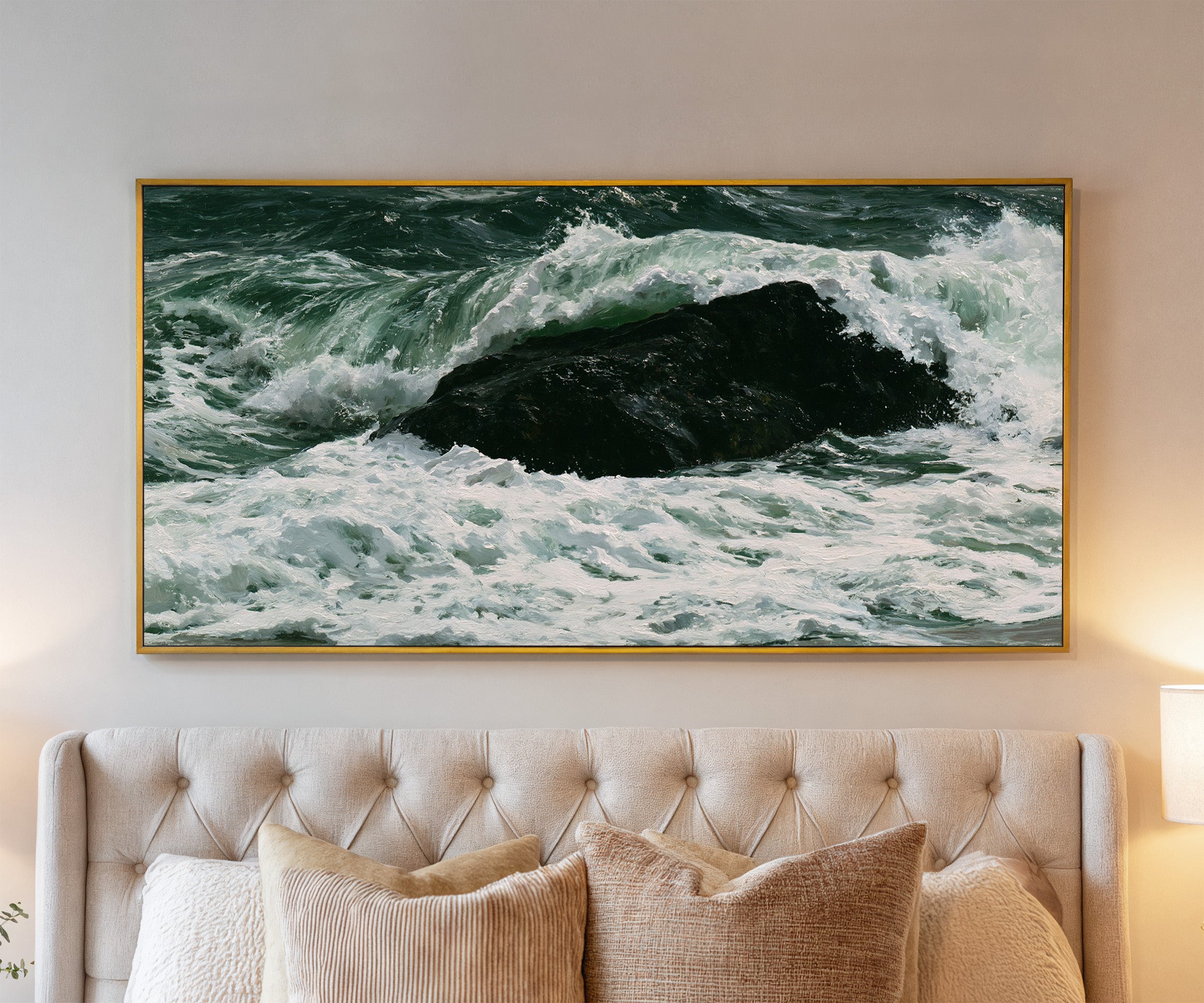 dark atlantic wave breaking over black rock canvas wall art in a gold frame above a bed