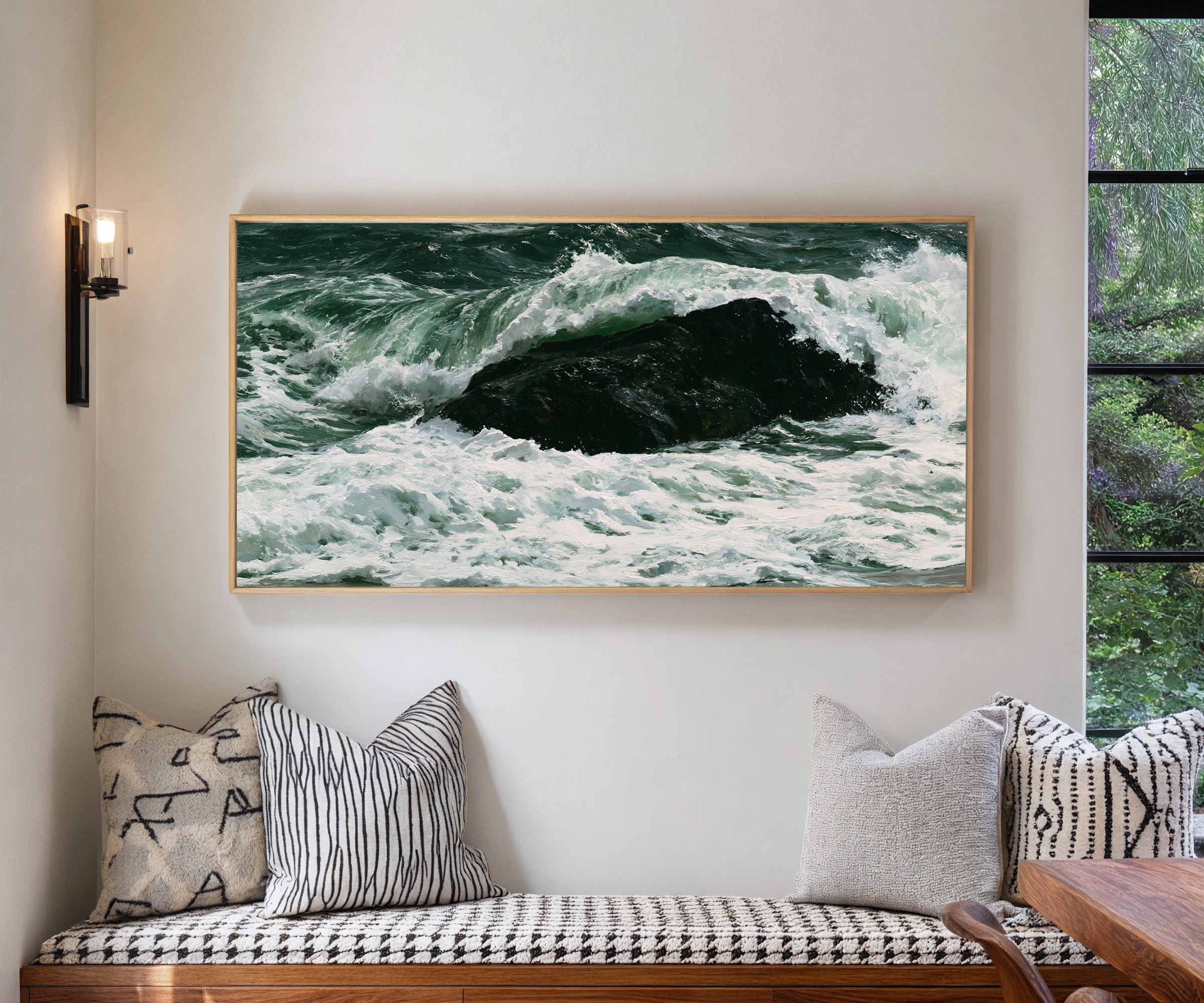 dark atlantic wave breaking over black rock canvas wall art in a natural wood frame in a living room