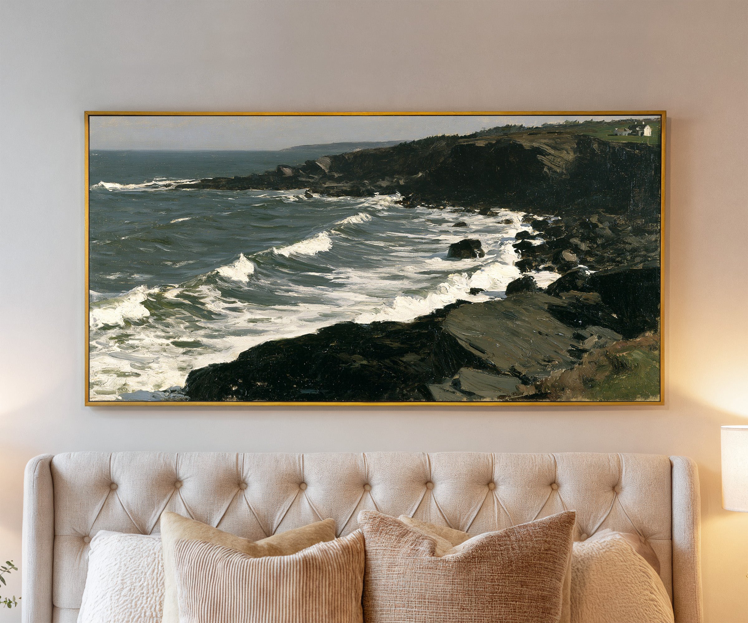 dark headland with white surf canvas wall art in a gold frame above a bed