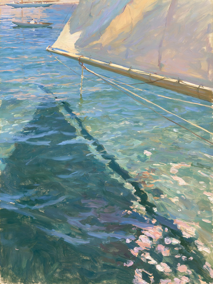 Cream sail leans over blue-green water with a dark wake and small boat near the horizon