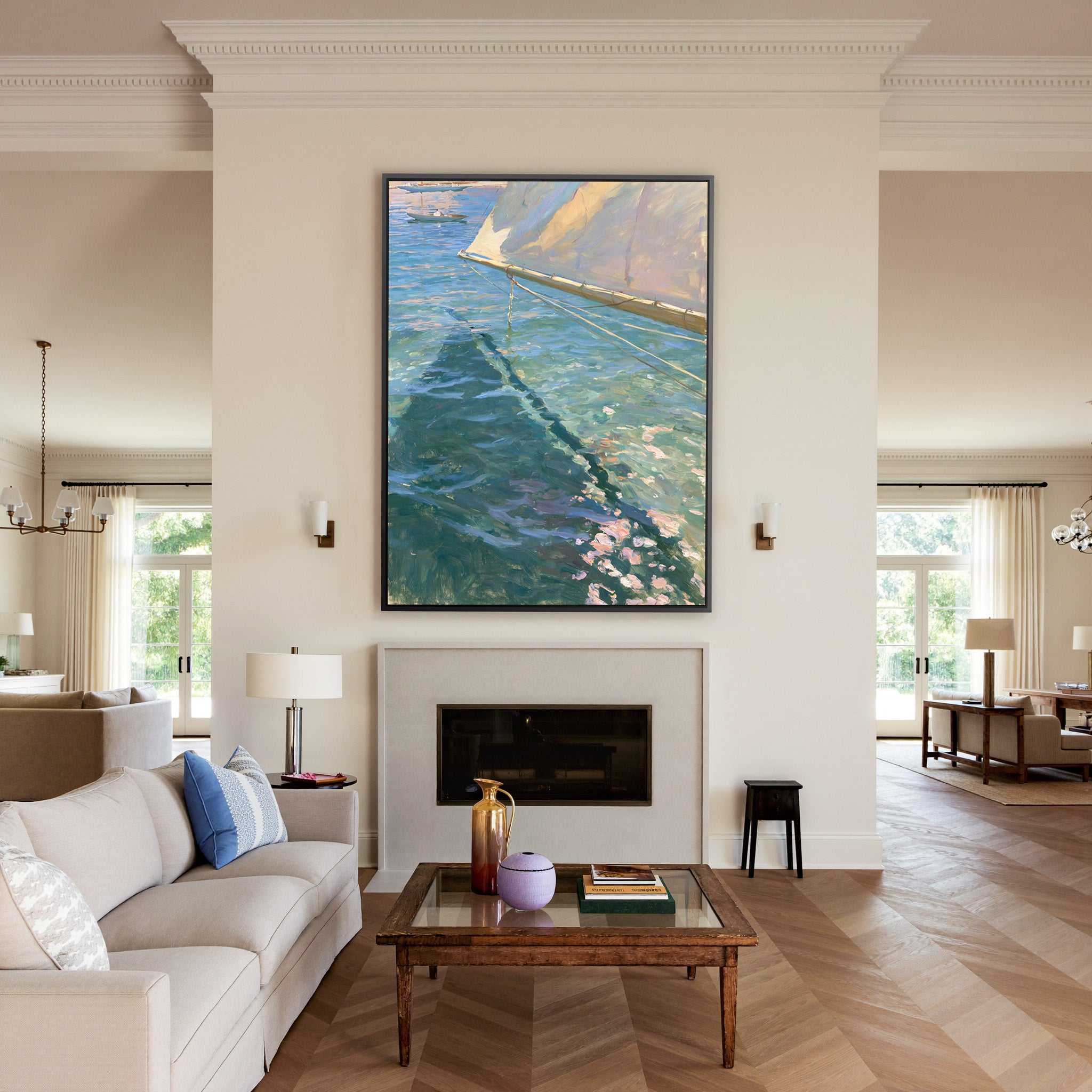 cream sail and blue water canvas wall art in a black frame above a mantel