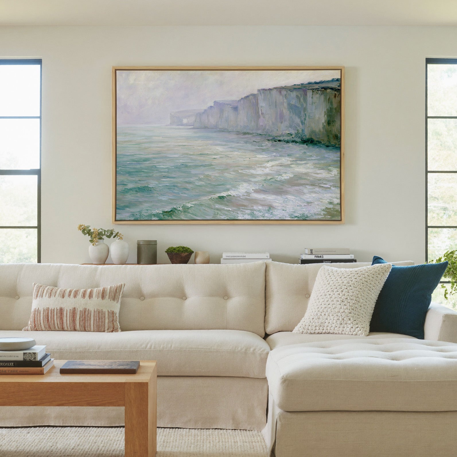 soft chalk cliffs above pale green sea canvas wall art in a natural wood frame in a living room