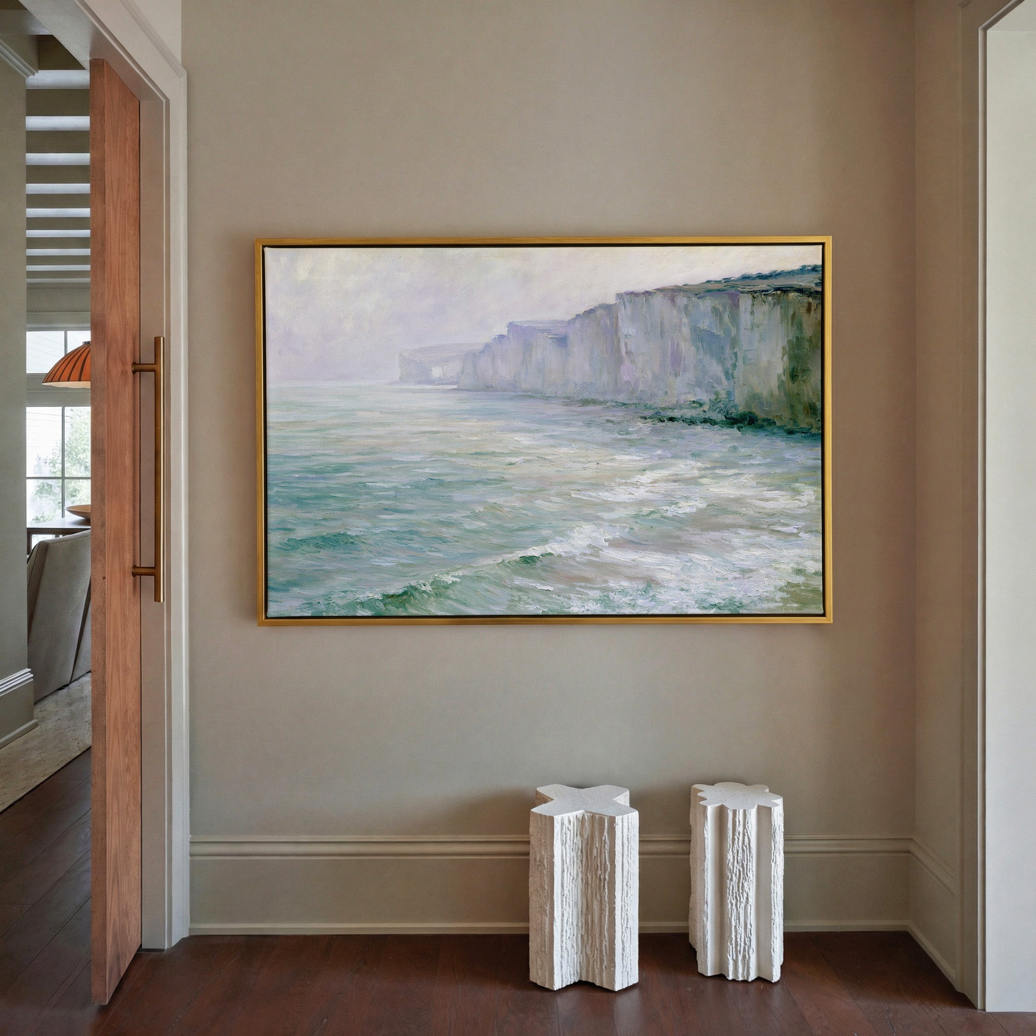soft chalk cliffs above pale green sea canvas wall art in a gold frame in a styled room setting