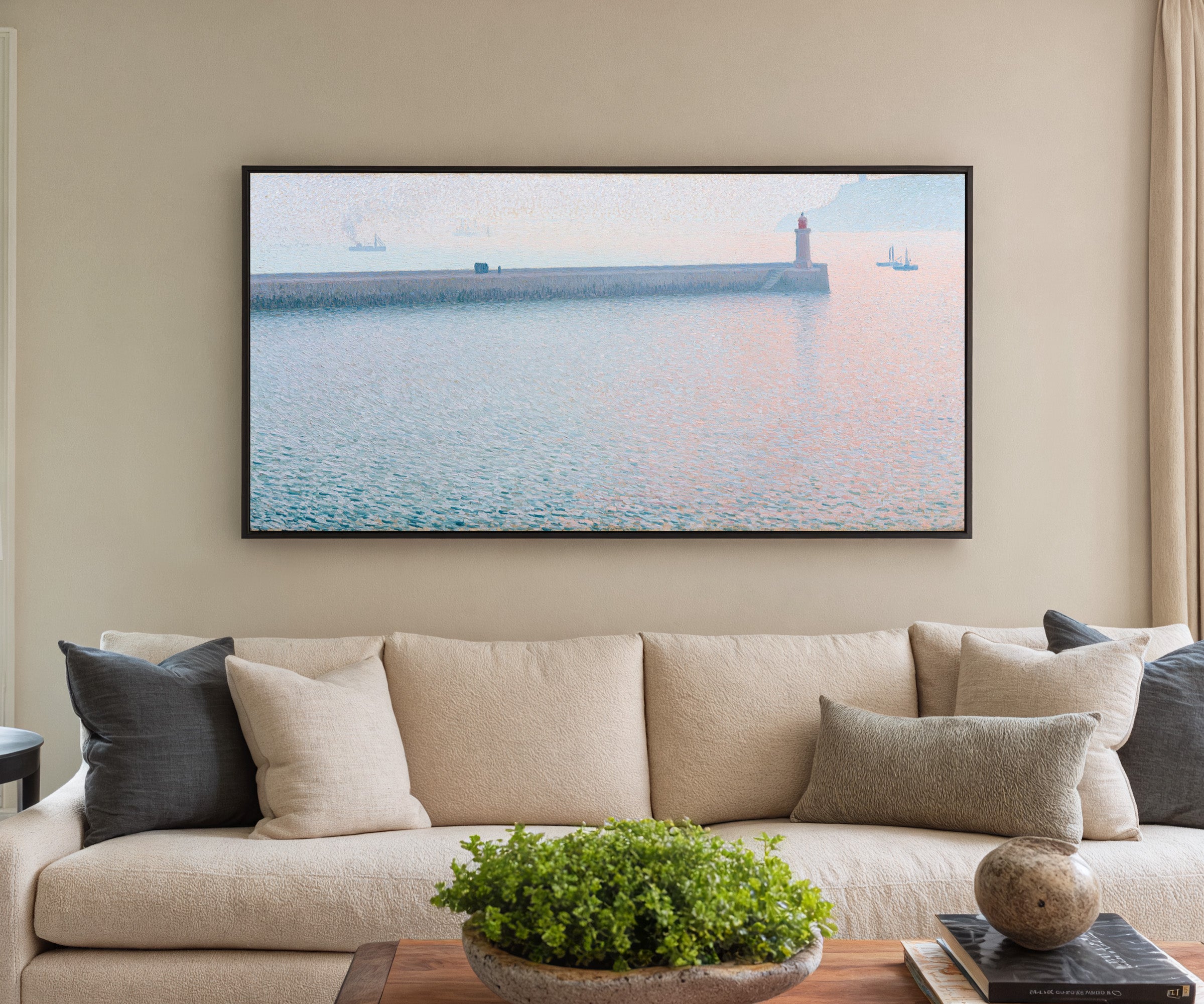 long harbor wall with a lighthouse and soft canvas wall art in a black frame in a styled room setting