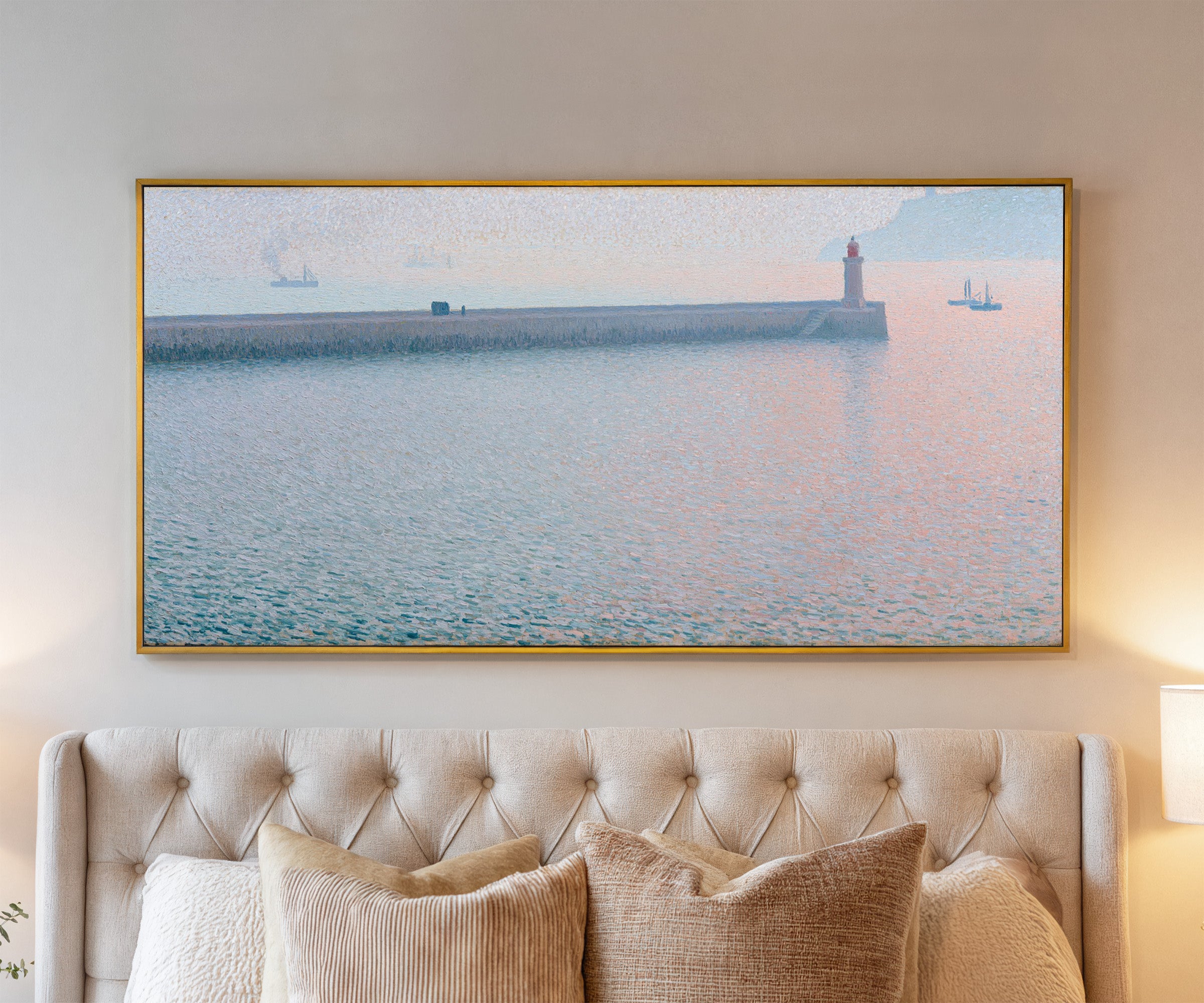 long harbor wall with a lighthouse and soft canvas wall art in a gold frame above a bed