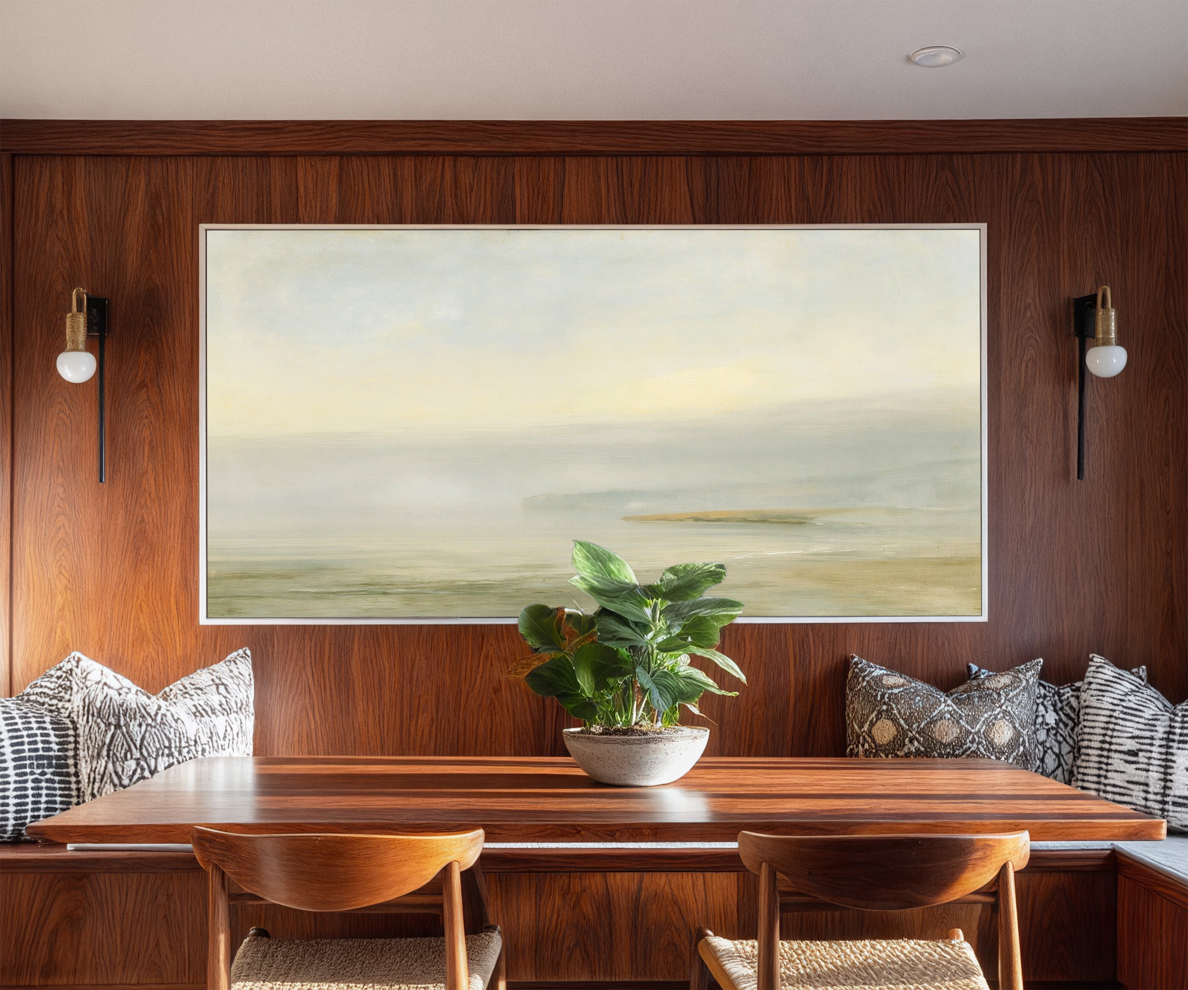 pale sea with a faint distant headland canvas wall art in a white frame in a styled room setting