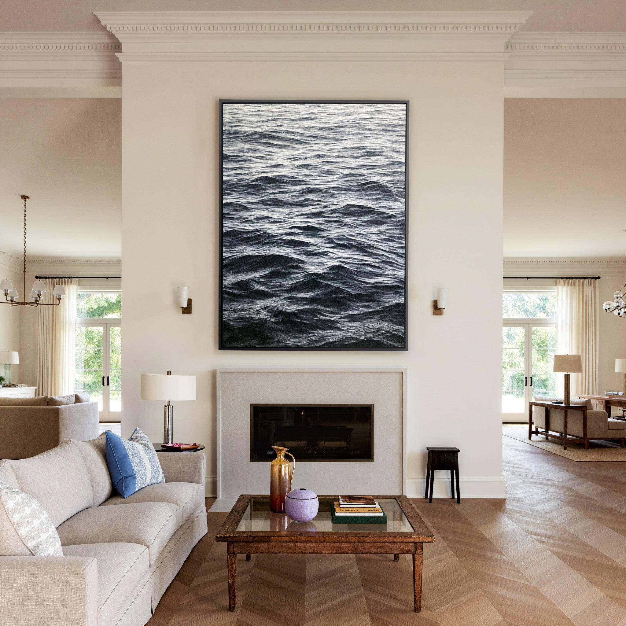 dark rippling ocean water canvas wall art in a black frame above a mantel
